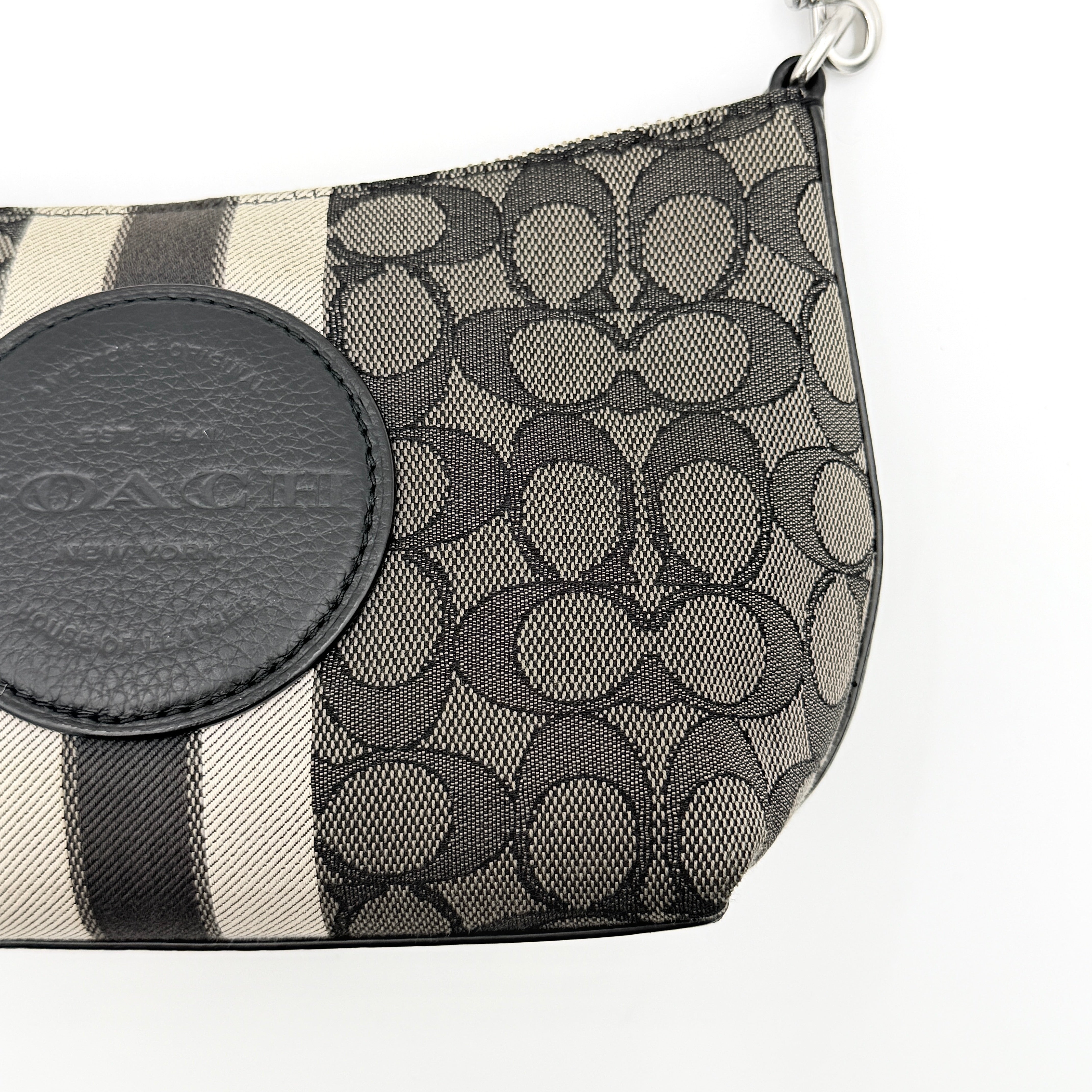 The Coach 2Way Signature Dempsey Stripe Shoulder Bag in black and grey canvas with detachable straps, shown flat on a white background.