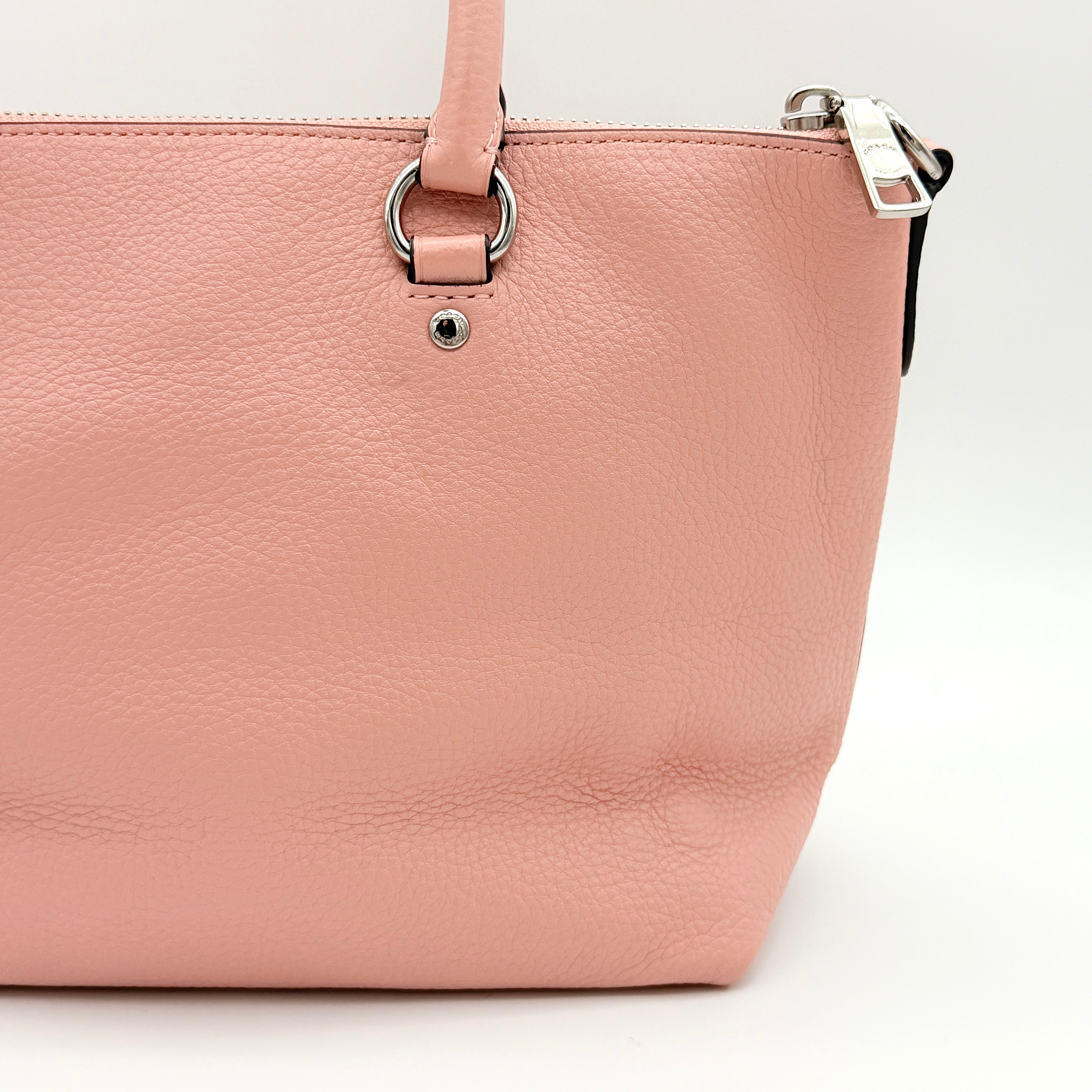 Coach Mini Emma Satchel in pink pebbled leather with silver-tone hardware, shown with detachable strap.