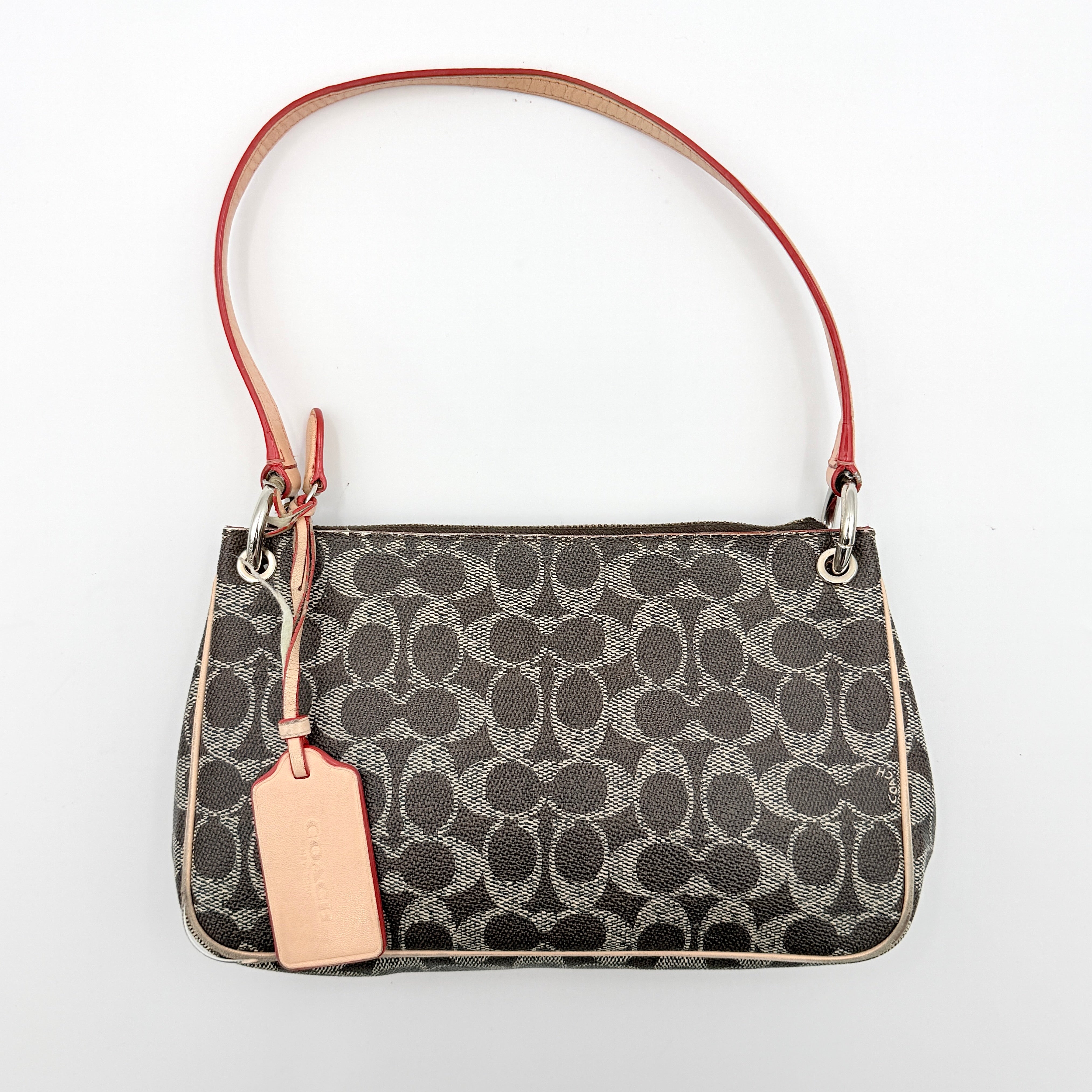Coach Signature Charley Shoulder Bag in grey and beige canvas with monogram print, tan leather trim, and a single leather strap.