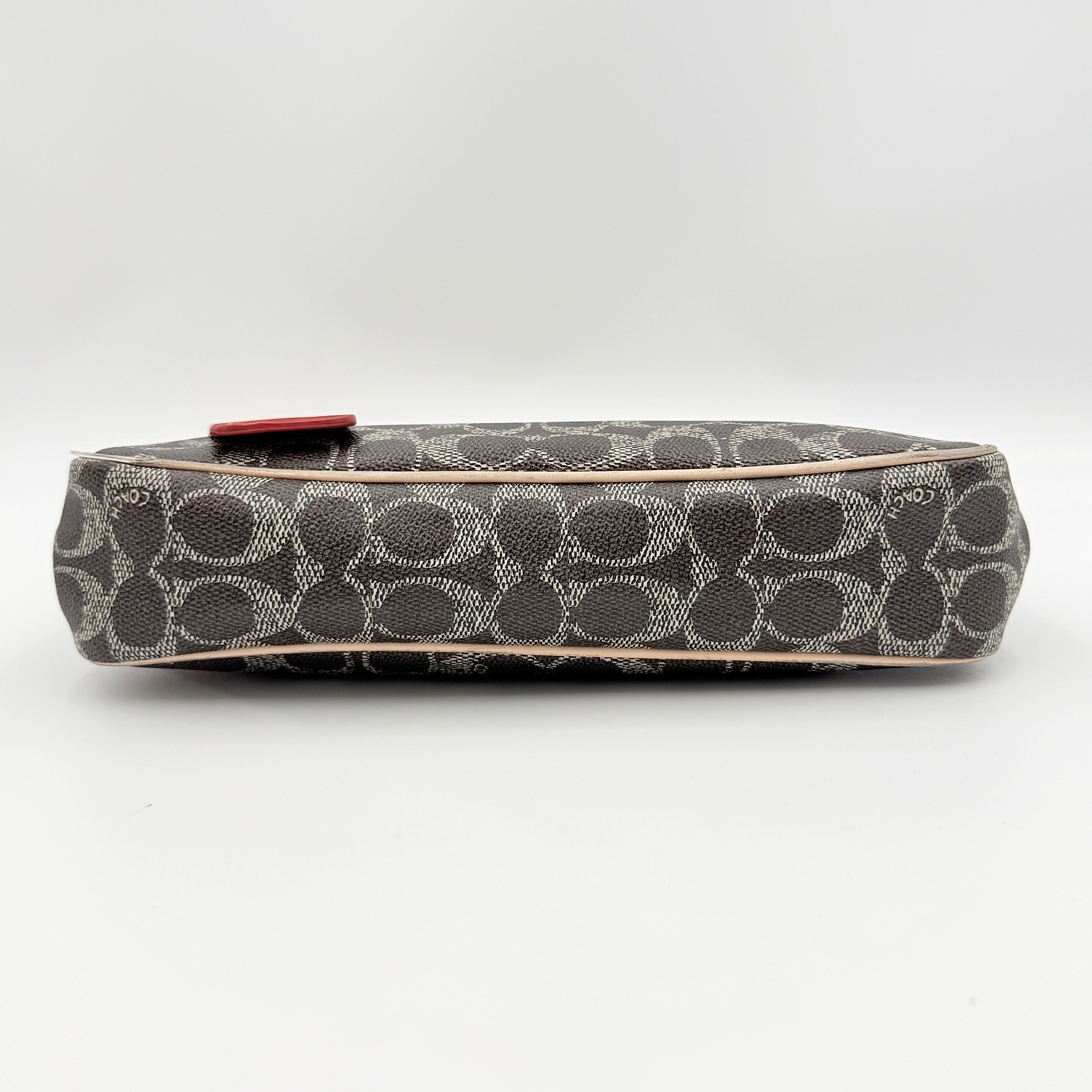 Coach Signature Charley Shoulder Bag in grey and beige canvas with monogram print, tan leather trim, and a single leather strap.