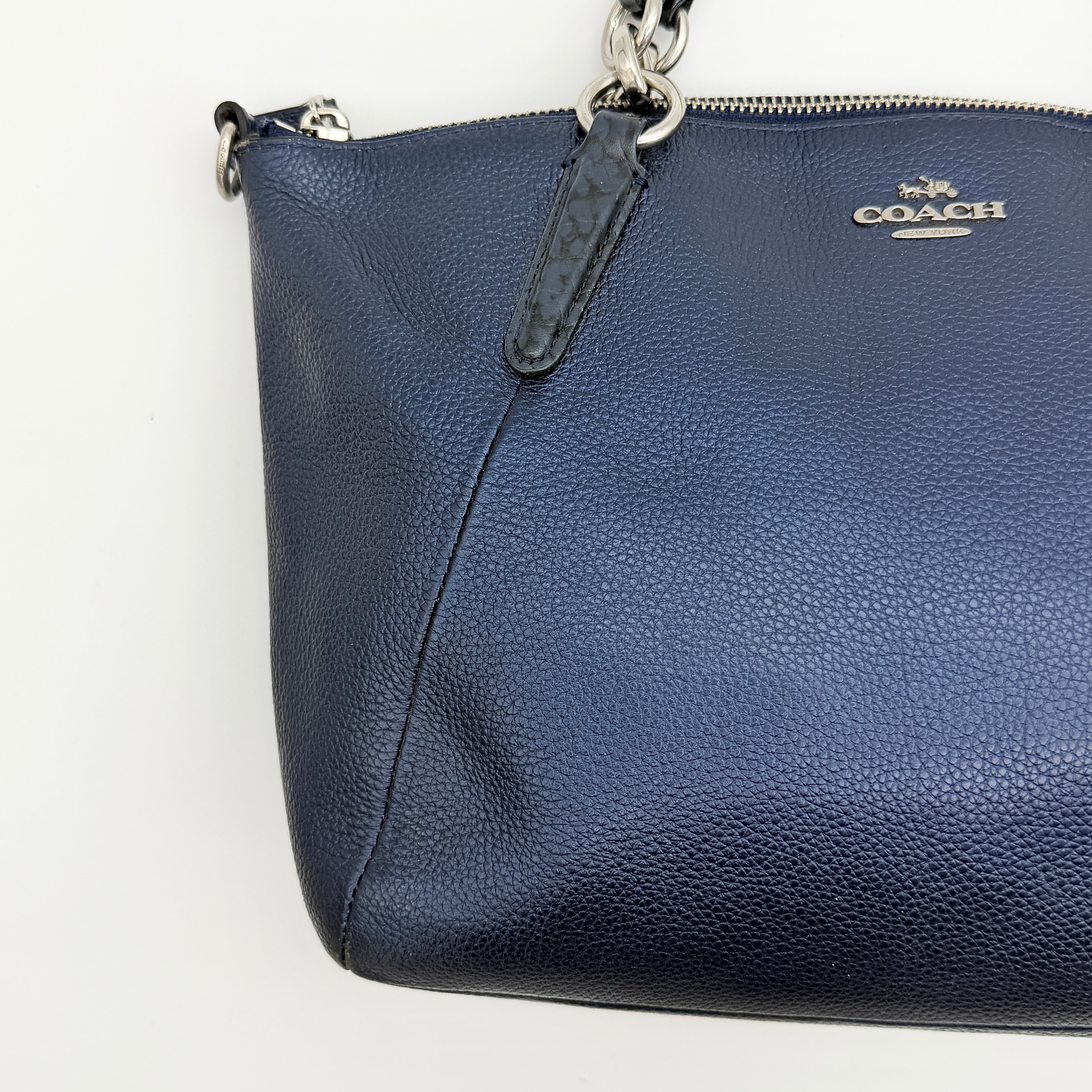 Coach Kelsey 2Way shoulder bag in navy blue pebble leather with silver-tone hardware, shown with detachable strap.