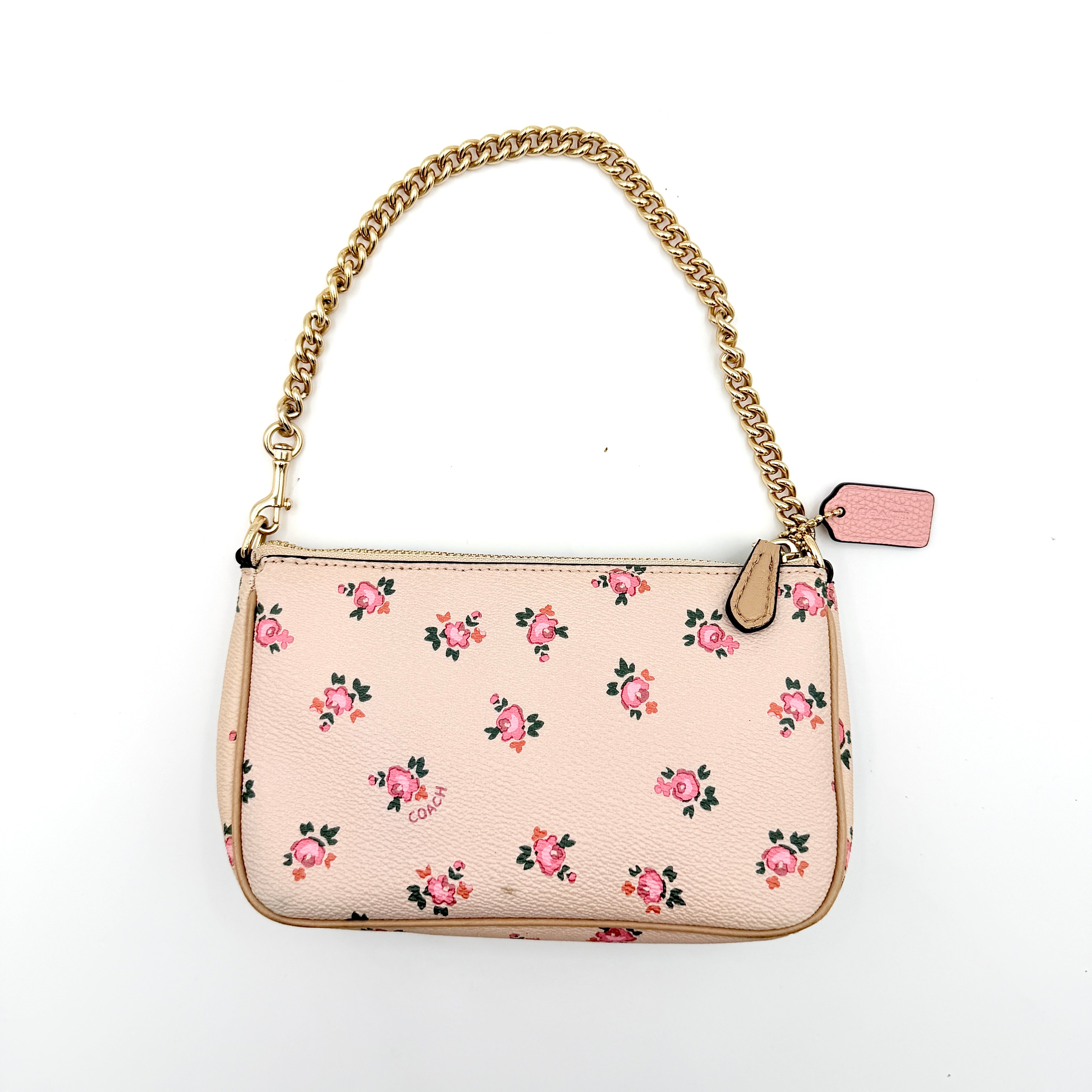 Coach Nolita 19 pink shoulder bag in floral print with gold chain handle, photographed against a white background.