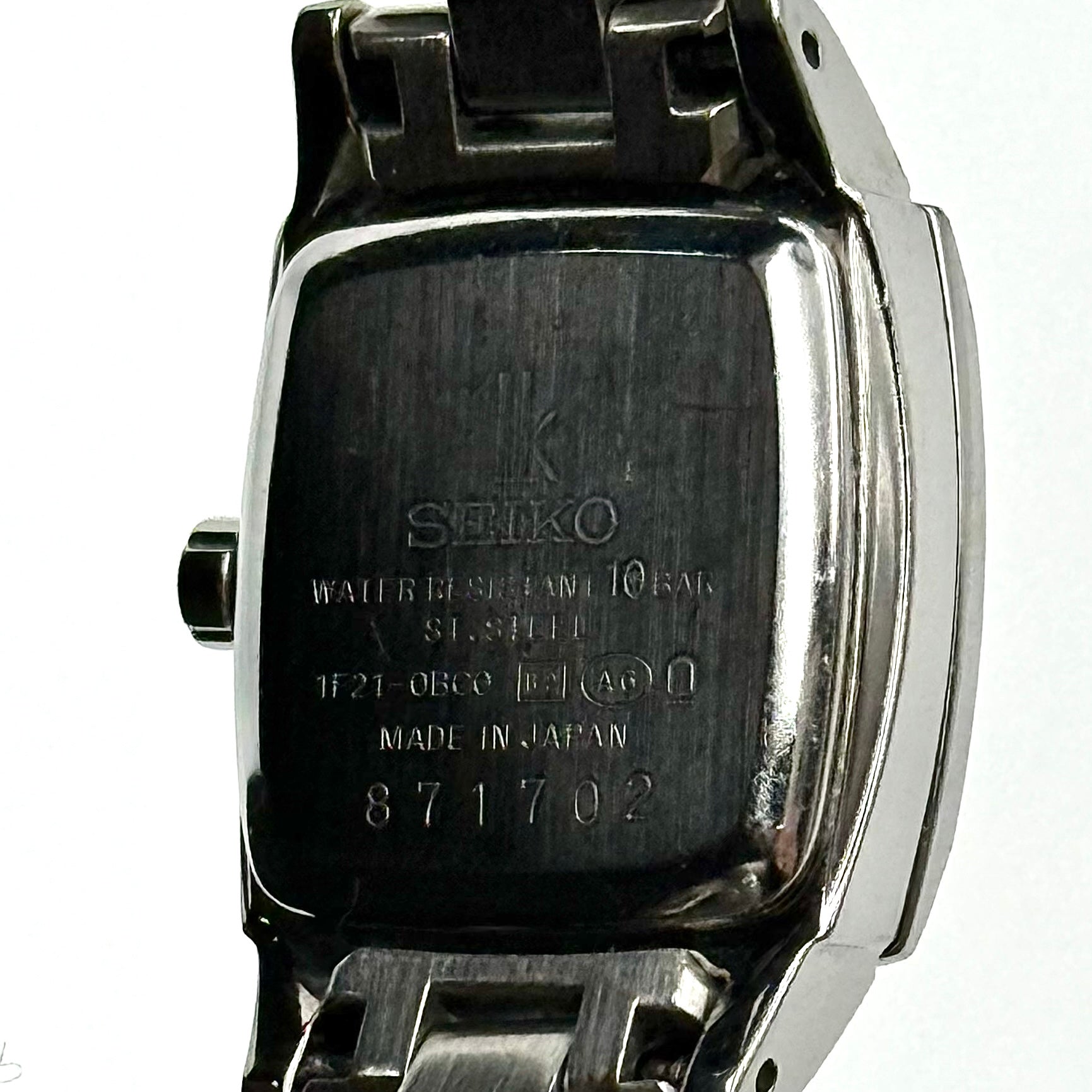 Seiko Lukia stainless steel watch with a rectangular case and silver dial presented on a cushion.
