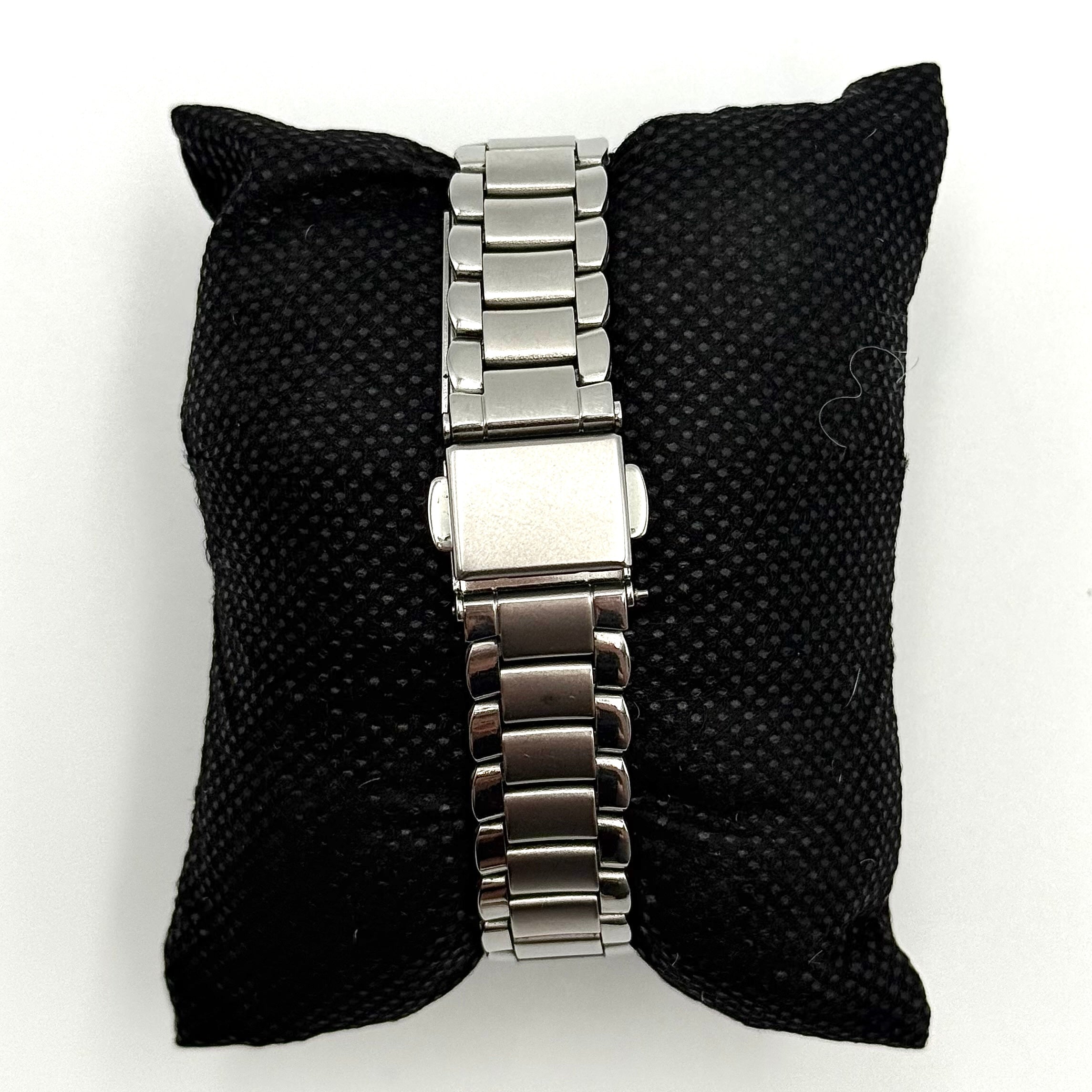 Coach CA.13.7.14.0431 stainless steel watch with brown dial and silver-tone bracelet, presented on a black cushion.