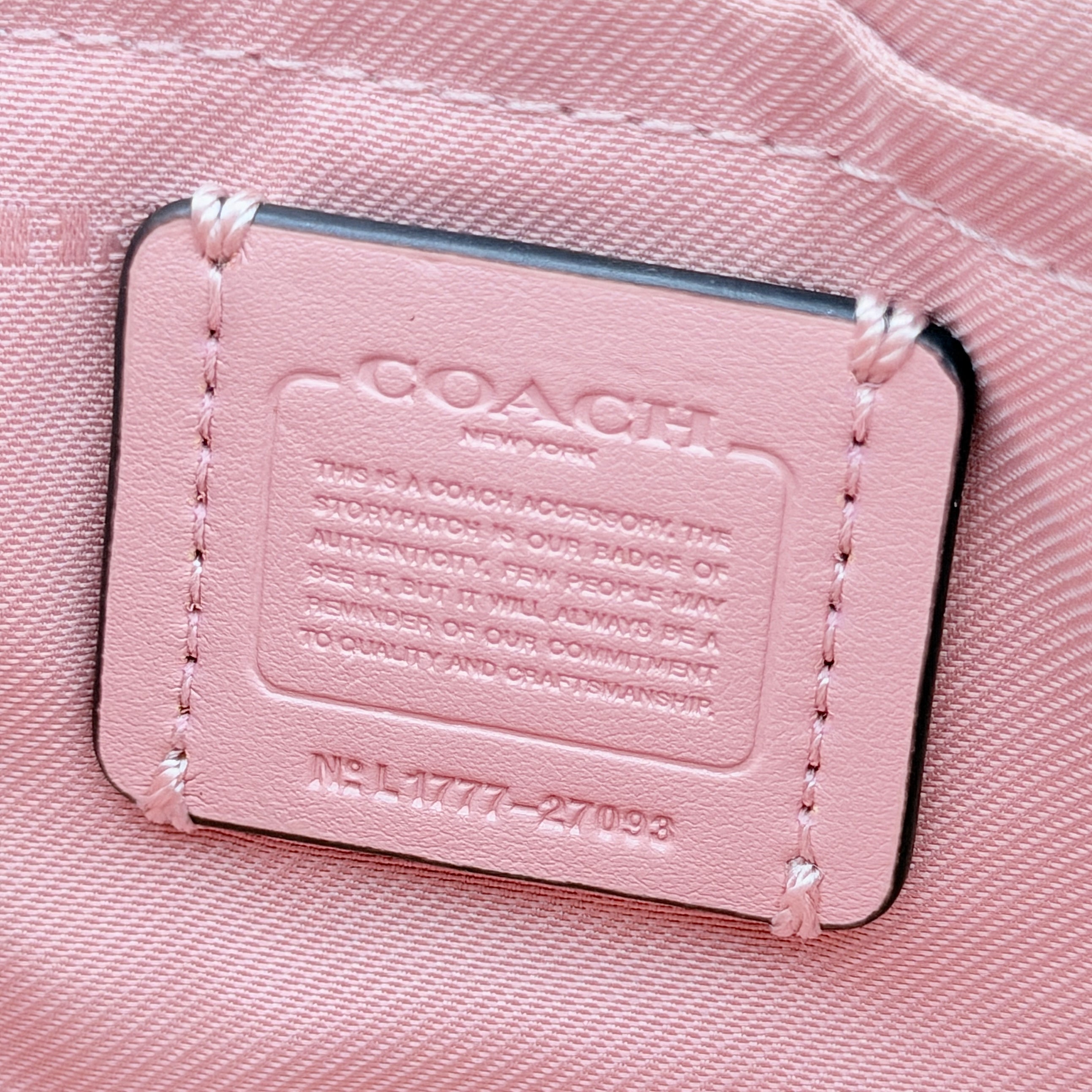 Coach Nolita 19 pink shoulder bag in floral print with gold chain handle, photographed against a white background.