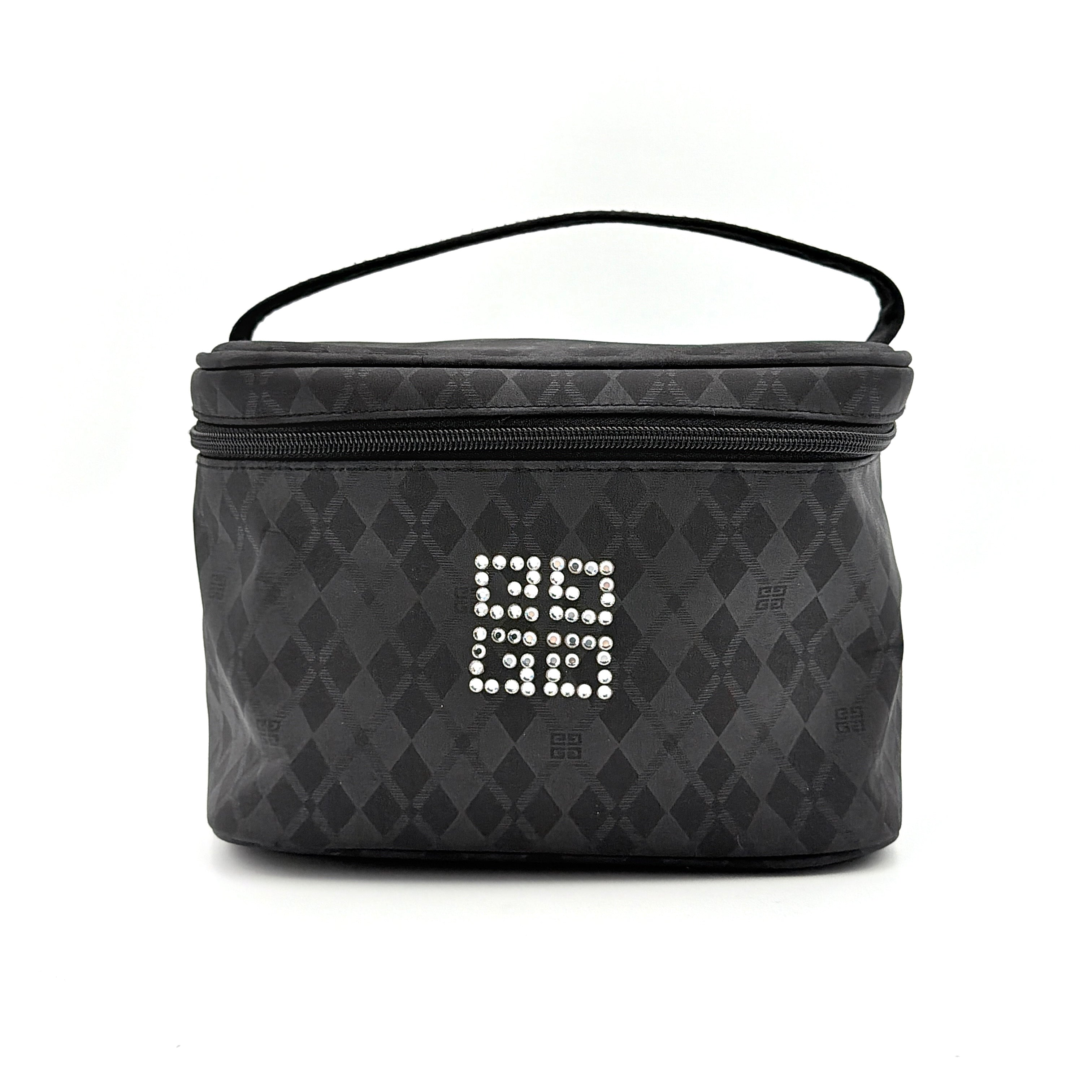 Givenchy vanity bag in black with rhinestone logo, geometric pattern, and top handle, shown from the front.