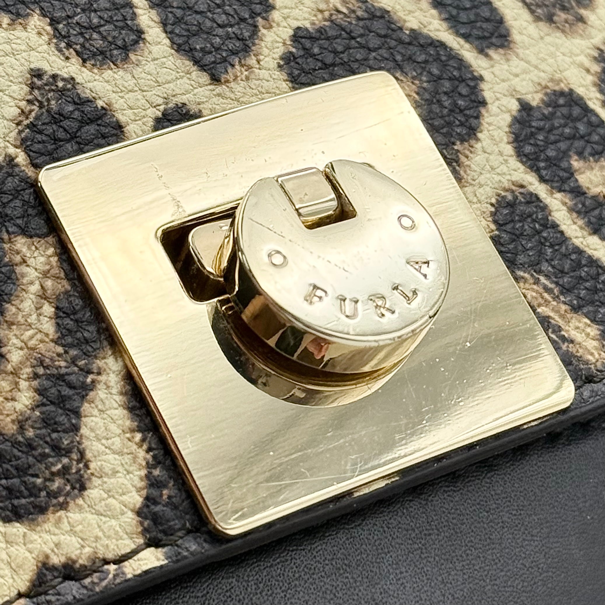 Furla 2Way Leopard Shoulder Bag in black leather with top handles, leopard print front, and detachable strap displayed beside it.