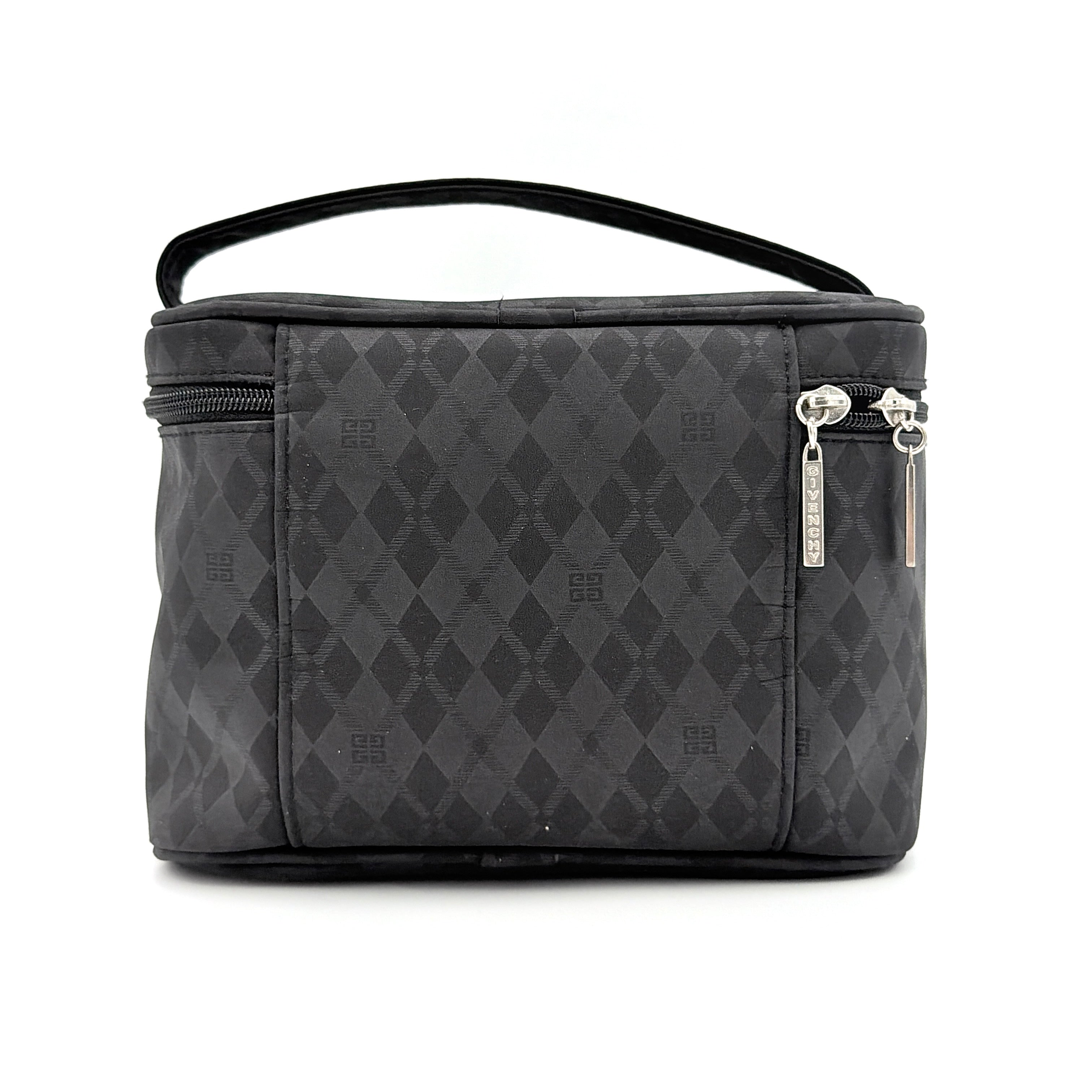 Givenchy vanity bag in black with rhinestone logo, geometric pattern, and top handle, shown from the front.