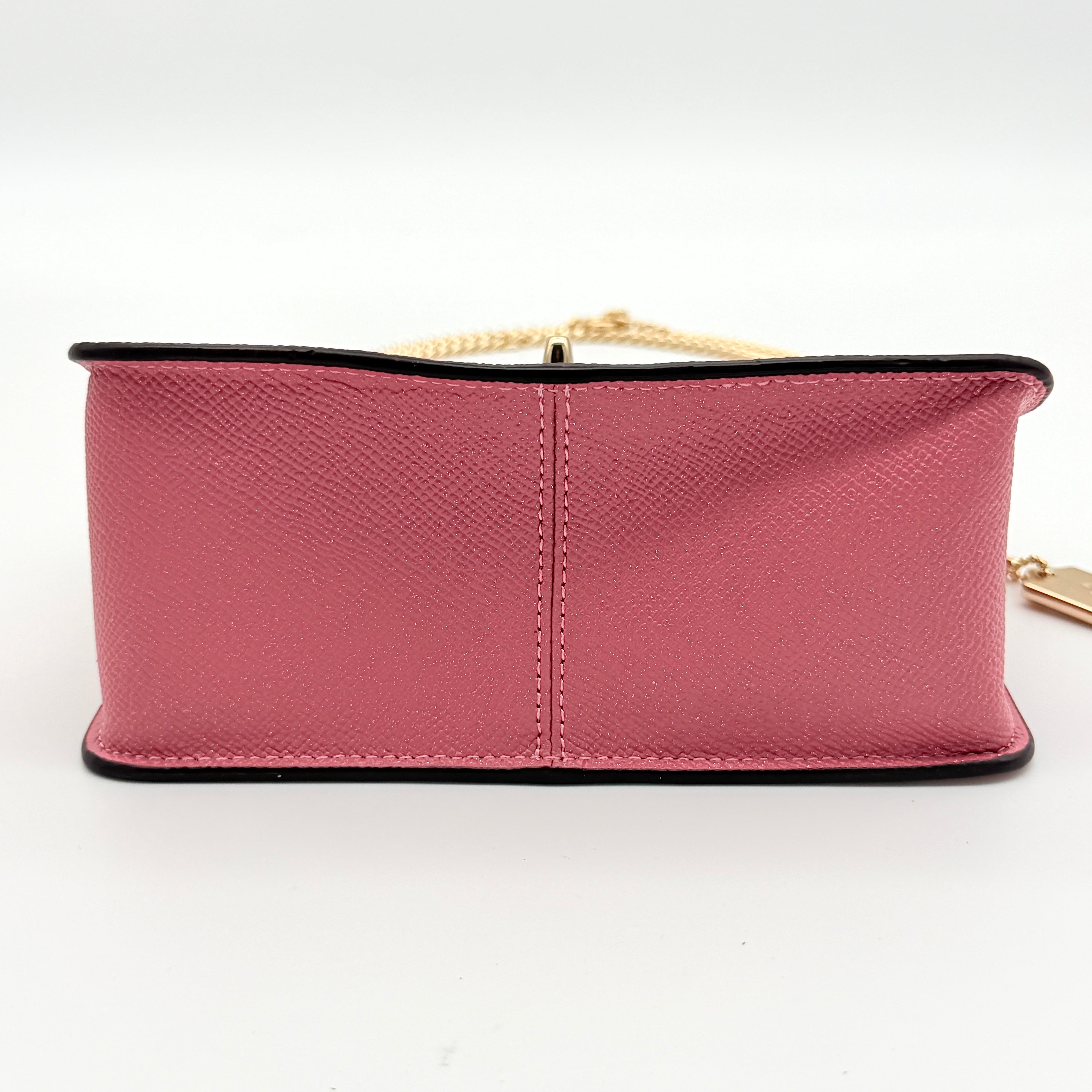 Coach Bowery Turnlock shoulder bag in pink saffiano leather with a gold-tone chain strap and signature Coach hangtag.
