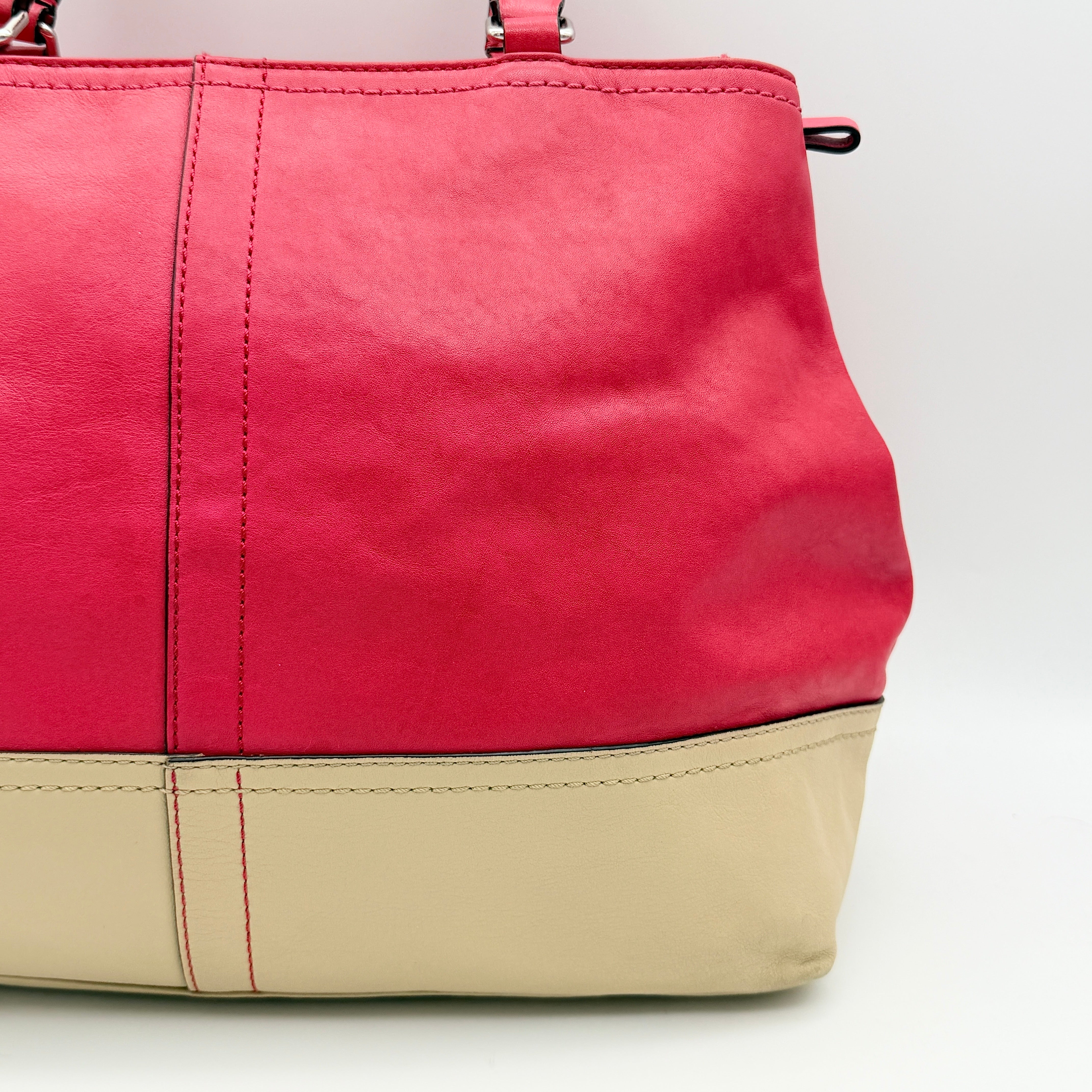 Coach Hamptons Weekend Perforated Tote in red and cream leather with dual top handles and silver hardware.