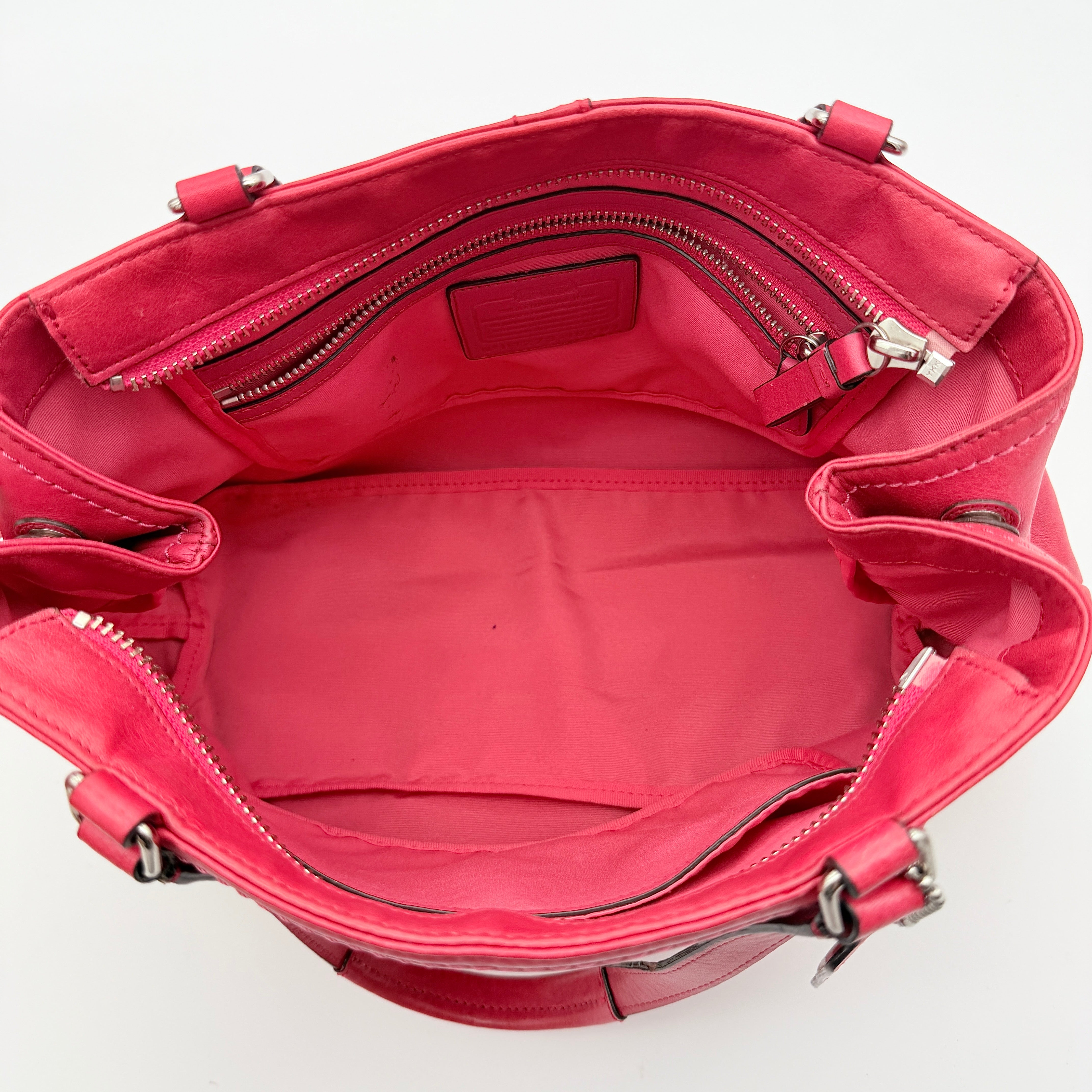 Coach Hamptons Weekend Perforated Tote in red and cream leather with dual top handles and silver hardware.