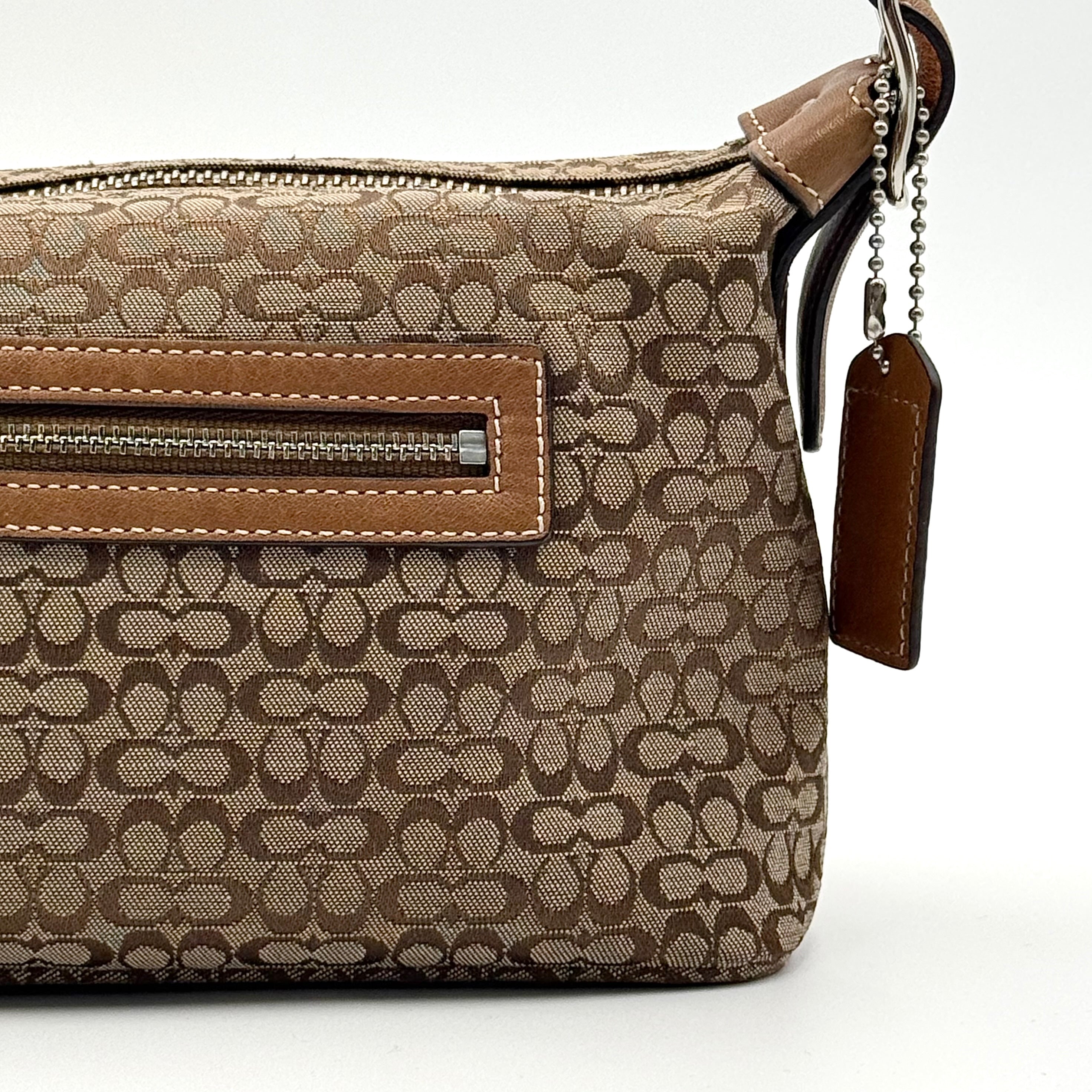Coach signature beige jacquard hobo shoulder bag with tan leather trim and silver-tone hardware.
