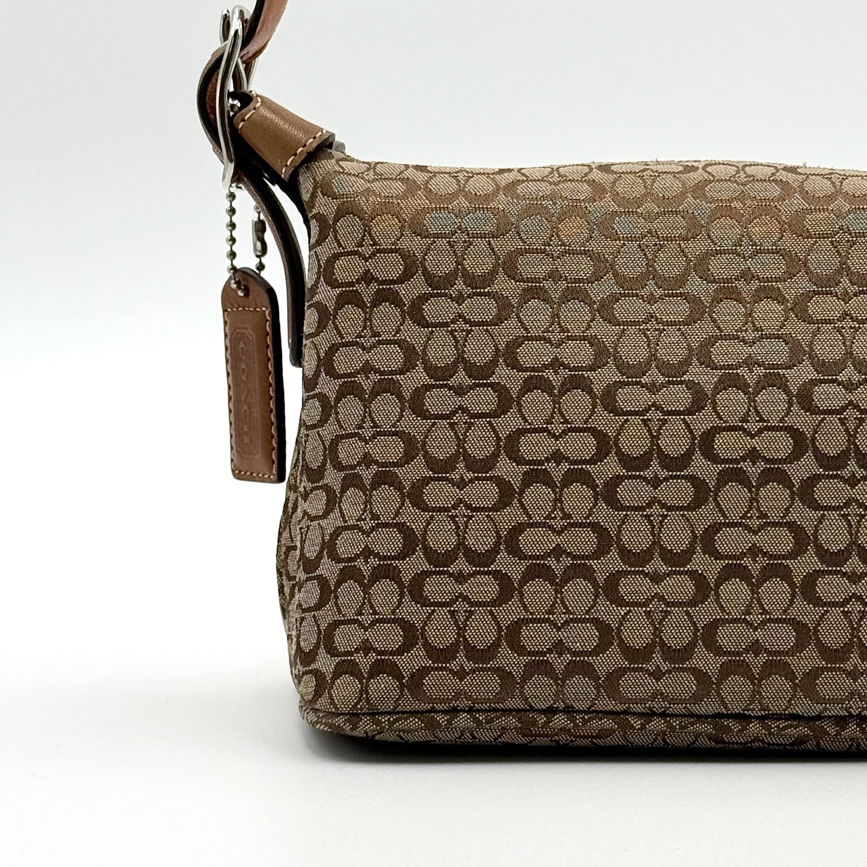 Coach signature beige jacquard hobo shoulder bag with tan leather trim and silver-tone hardware.