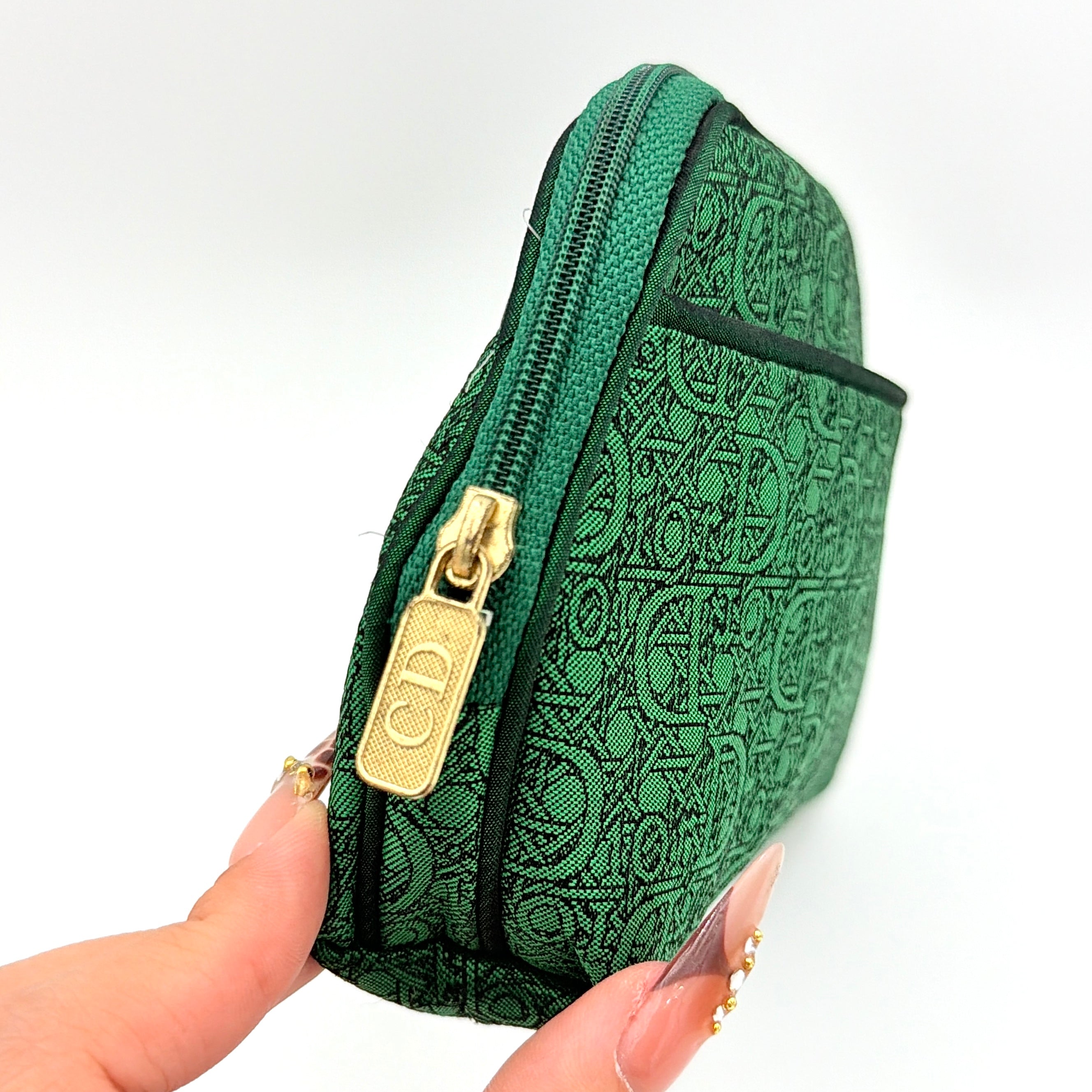 Green Christian Dior Oblique cosmetic pouch with monogram canvas and gold-tone zip, shown from the front.
