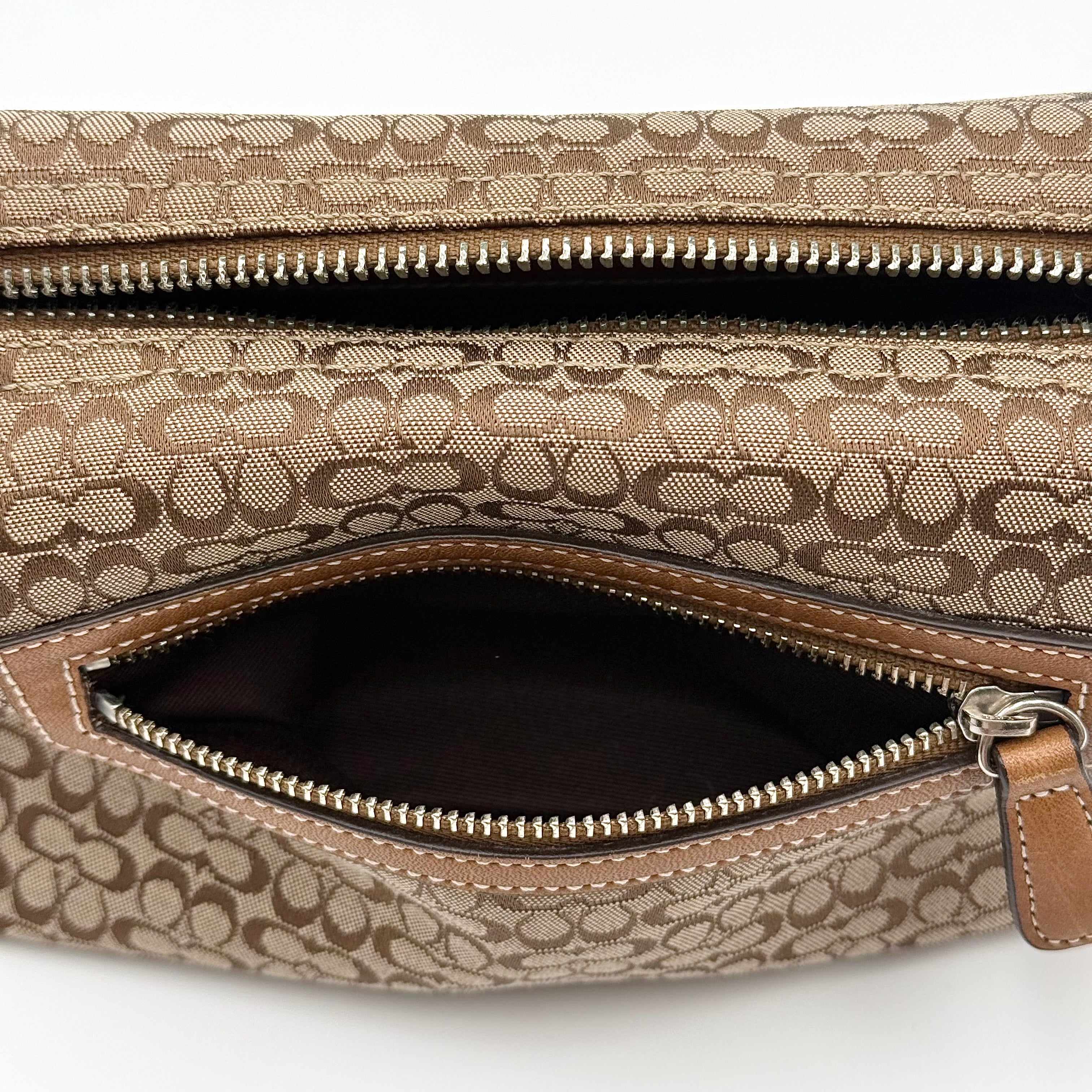 Coach signature beige jacquard hobo shoulder bag with tan leather trim and silver-tone hardware.