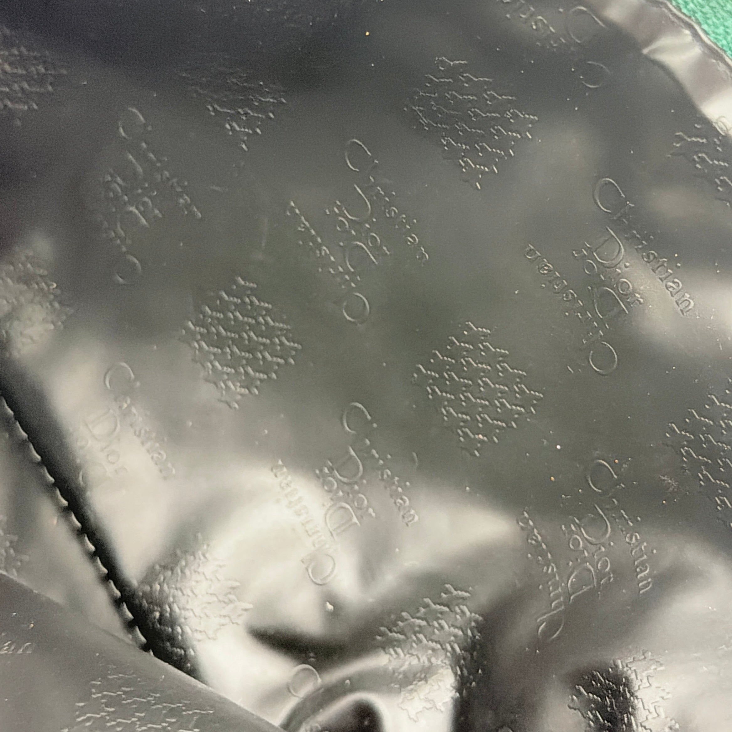 Green Christian Dior Oblique cosmetic pouch with monogram canvas and gold-tone zip, shown from the front.