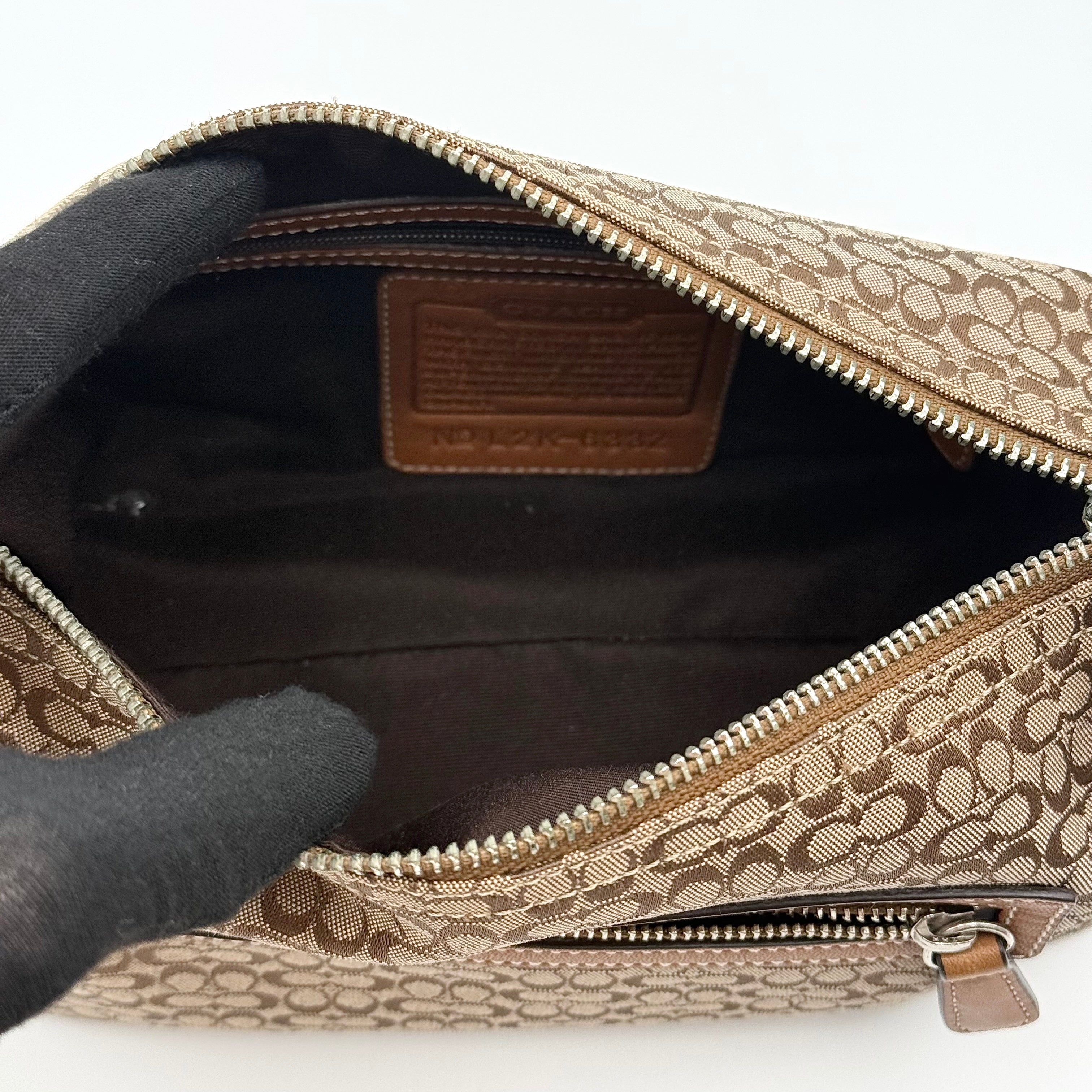 Coach signature beige jacquard hobo shoulder bag with tan leather trim and silver-tone hardware.