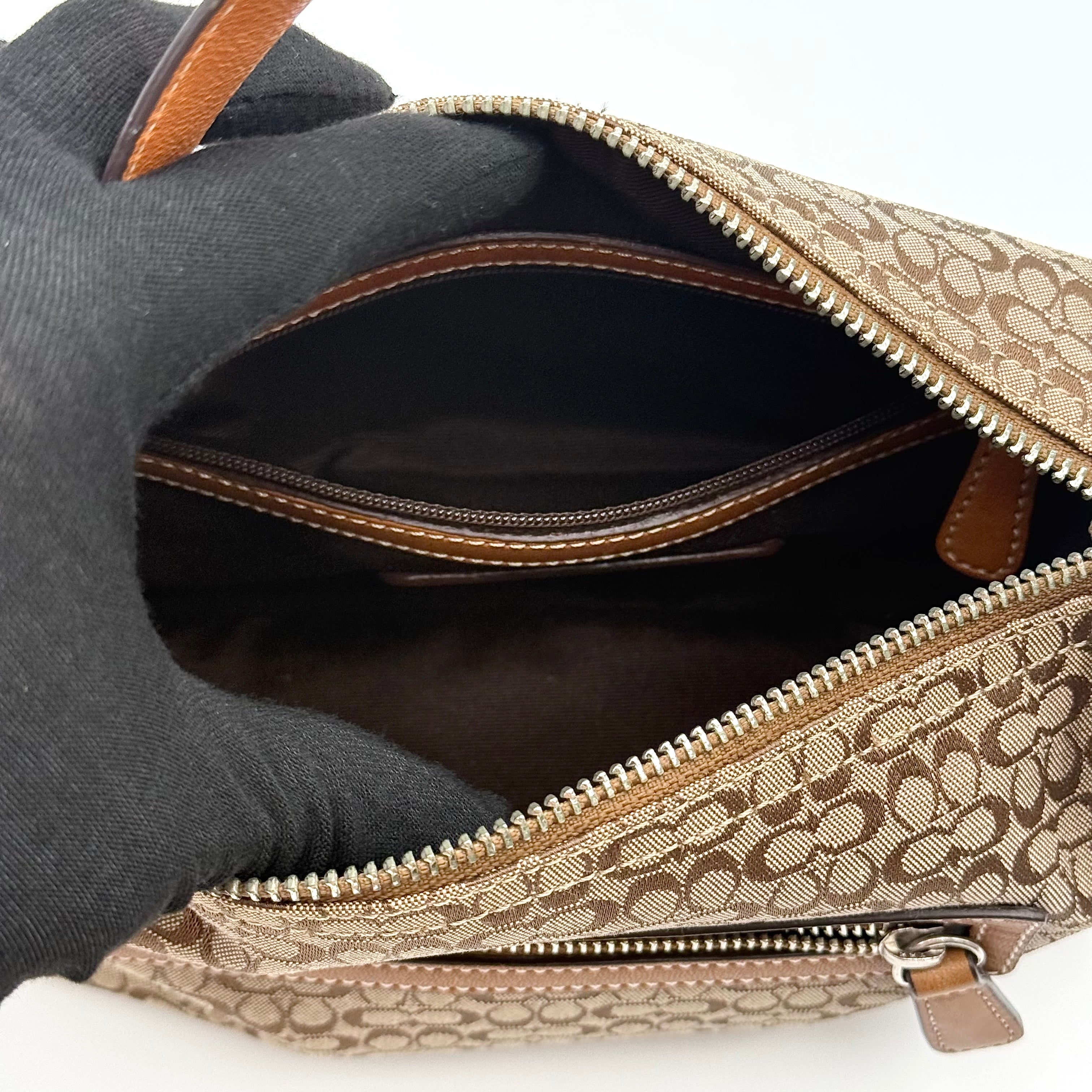 Coach signature beige jacquard hobo shoulder bag with tan leather trim and silver-tone hardware.