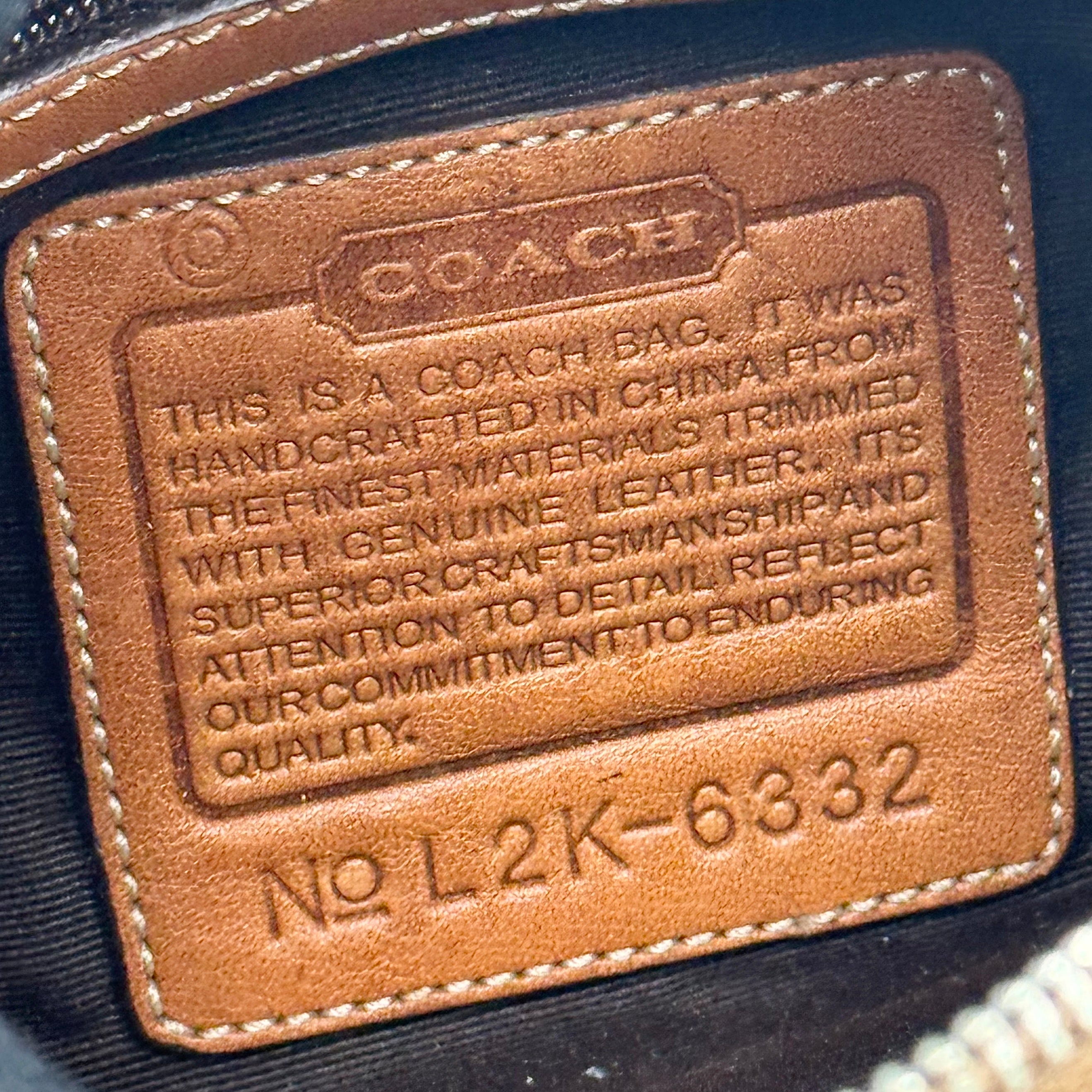 Coach signature beige jacquard hobo shoulder bag with tan leather trim and silver-tone hardware.