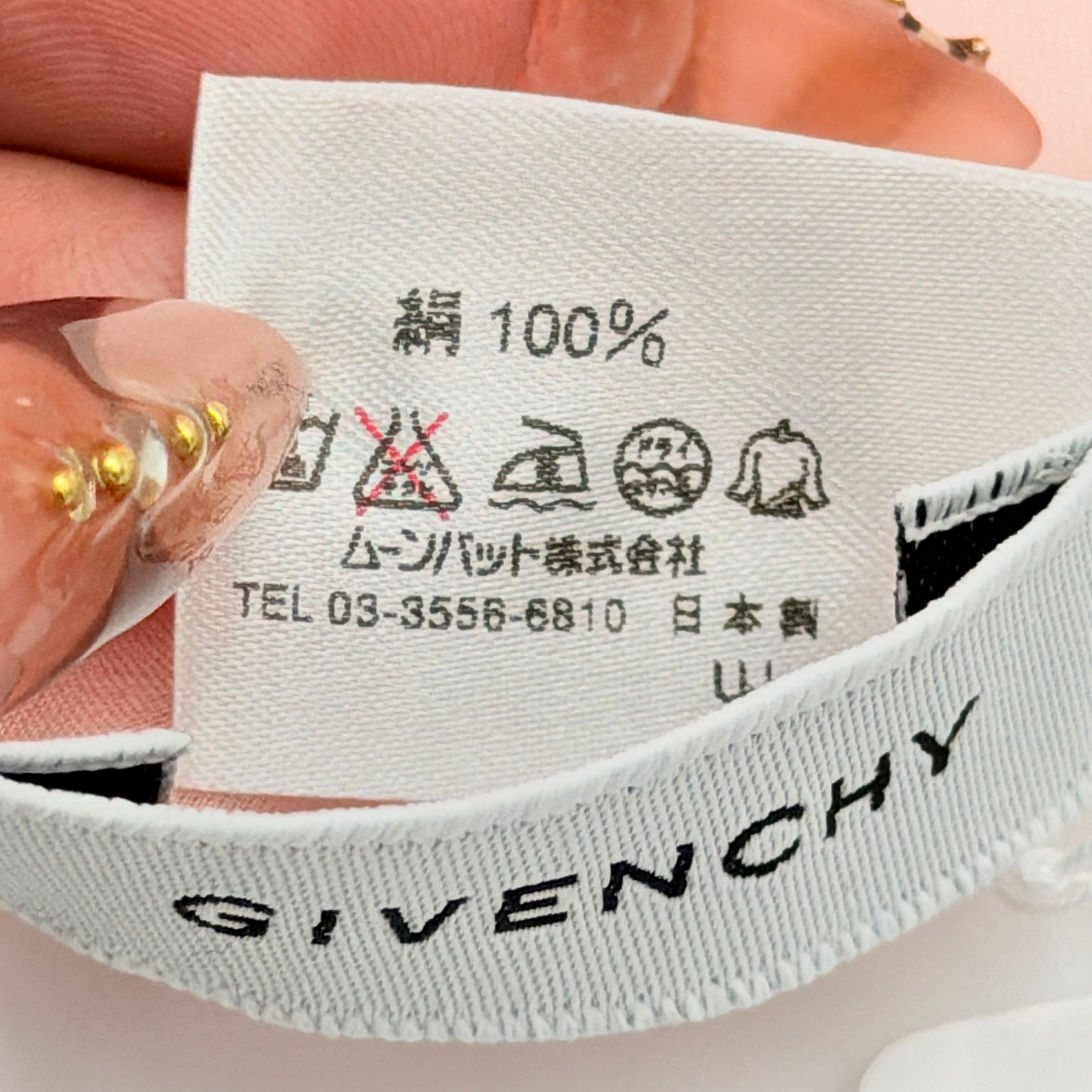 Givenchy silk scarf in pink with orange monogram pattern, showing the full length and original tags attached.