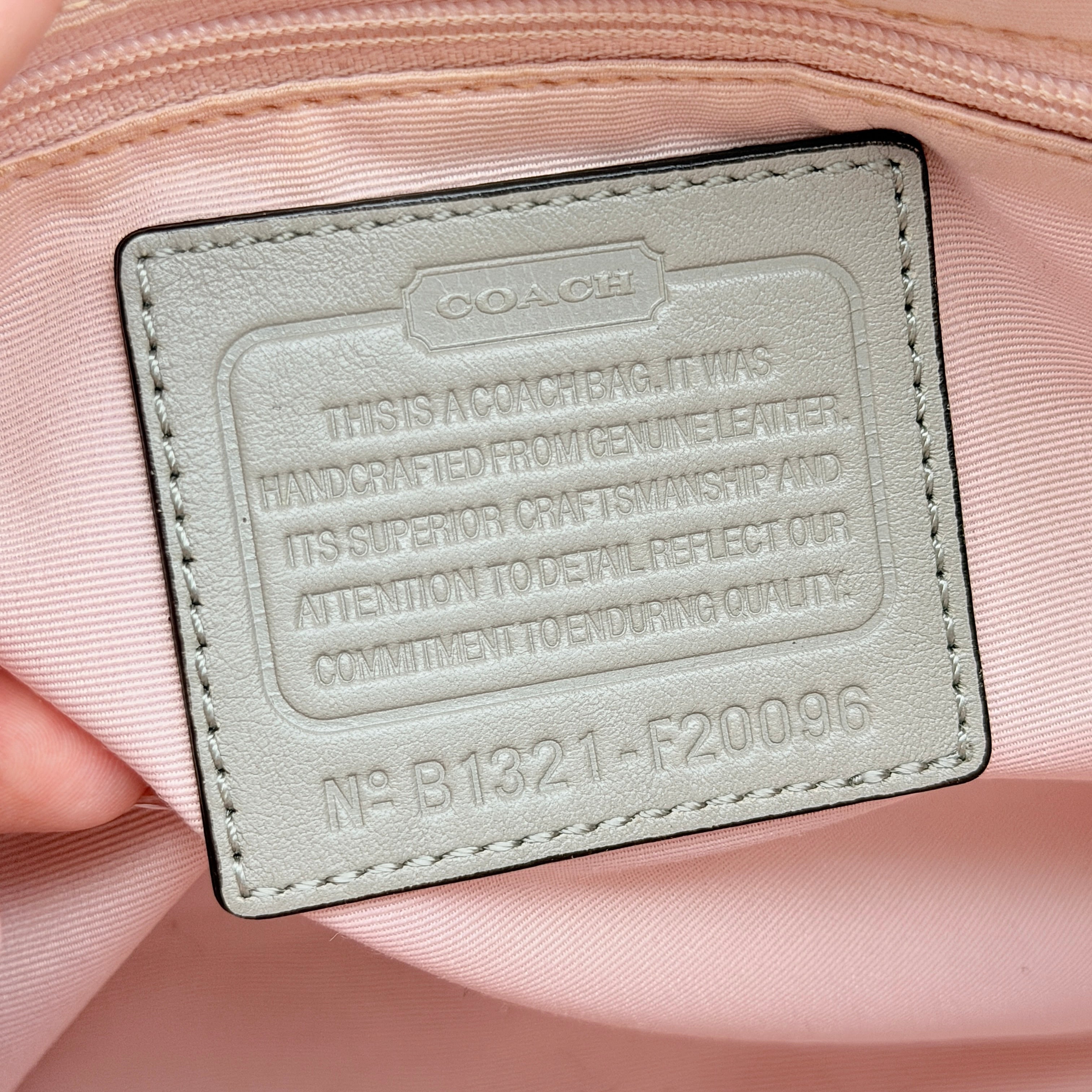Coach Peyton embossed patent shoulder bag in yellow with tan leather trim and double handles, shown against a white background.