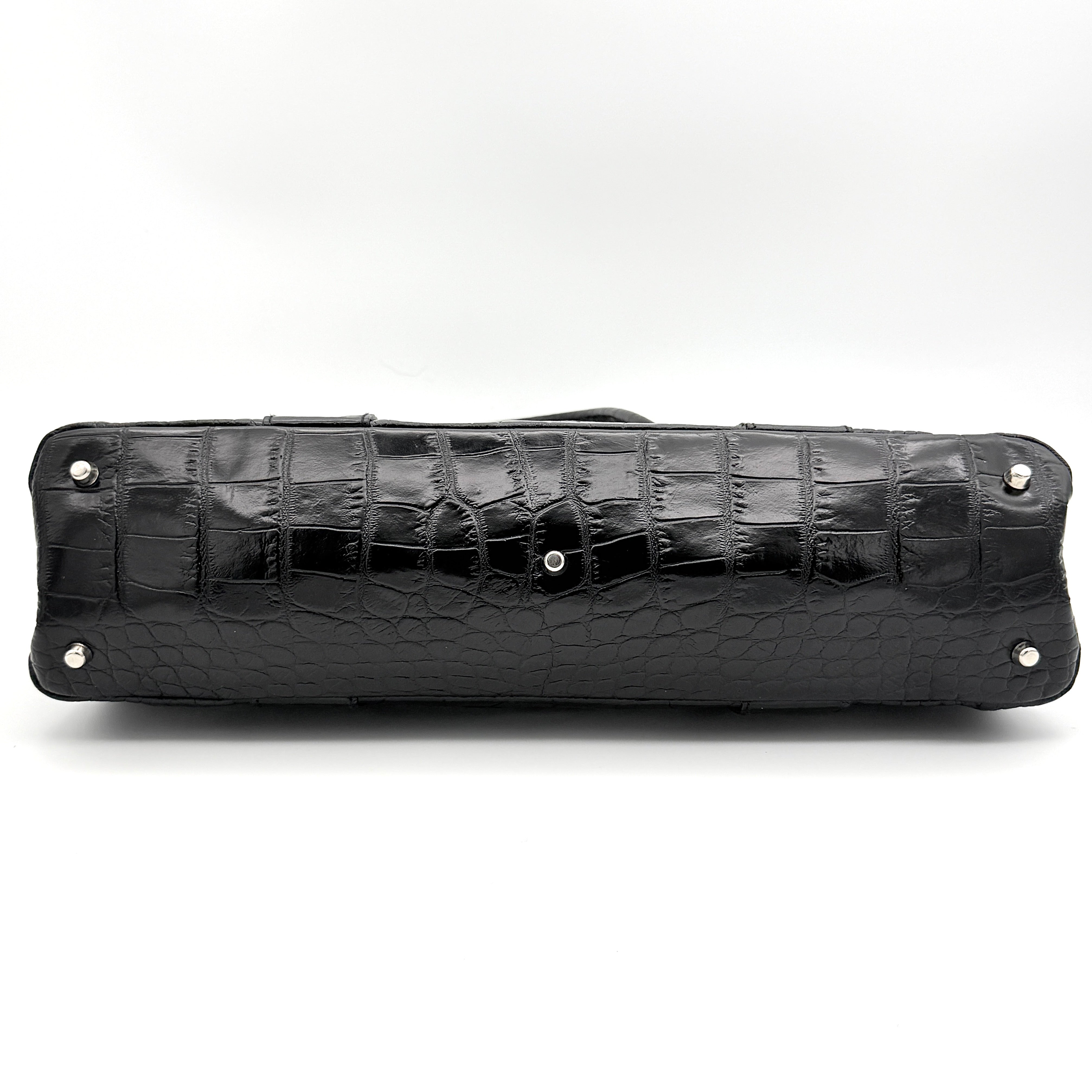 Furla croc-embossed black leather shoulder bag with suede panels and double handles, displayed against a white background.