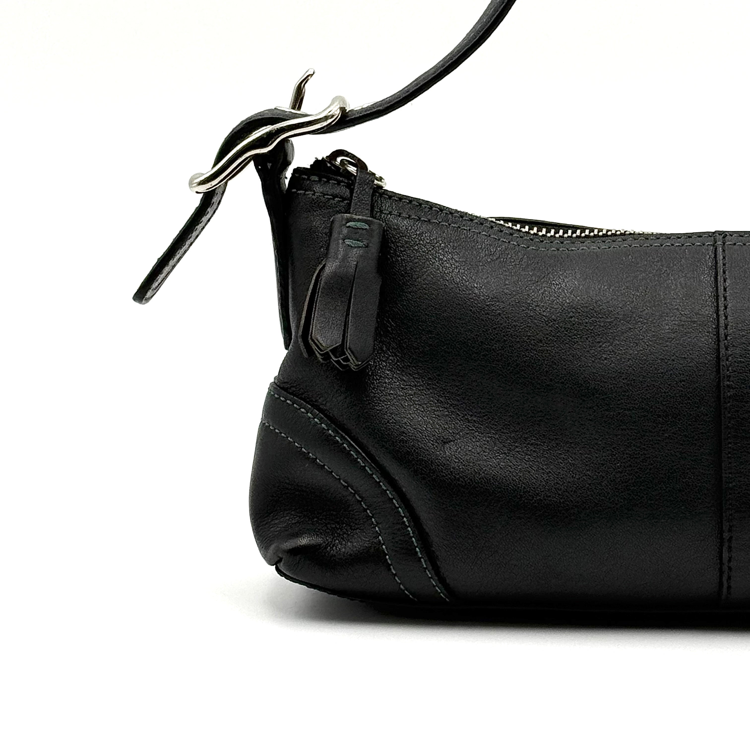 Coach Hampton Demi Baguette shoulder bag in smooth black leather with a curved top handle and silver-tone hardware.