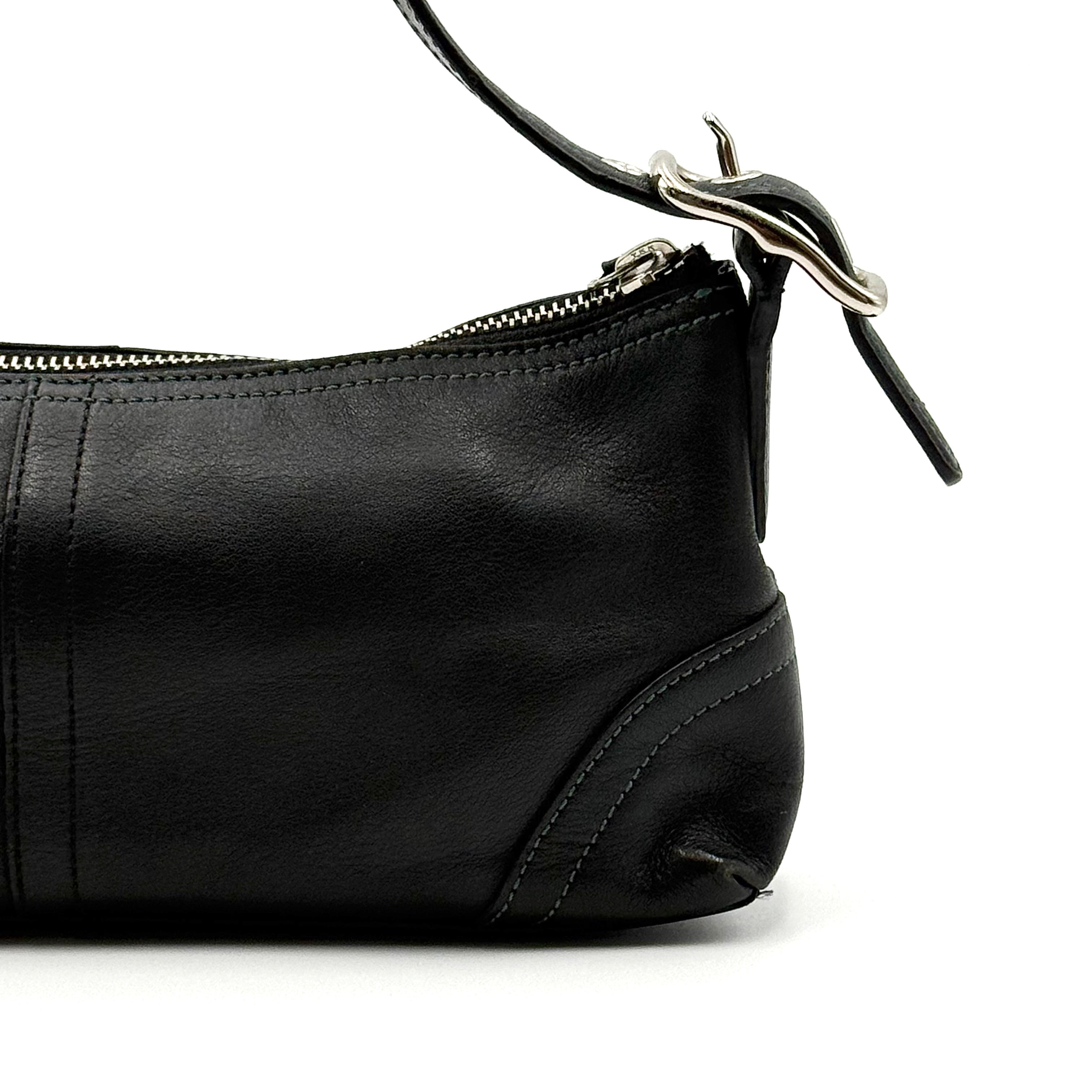 Coach Hampton Demi Baguette shoulder bag in smooth black leather with a curved top handle and silver-tone hardware.