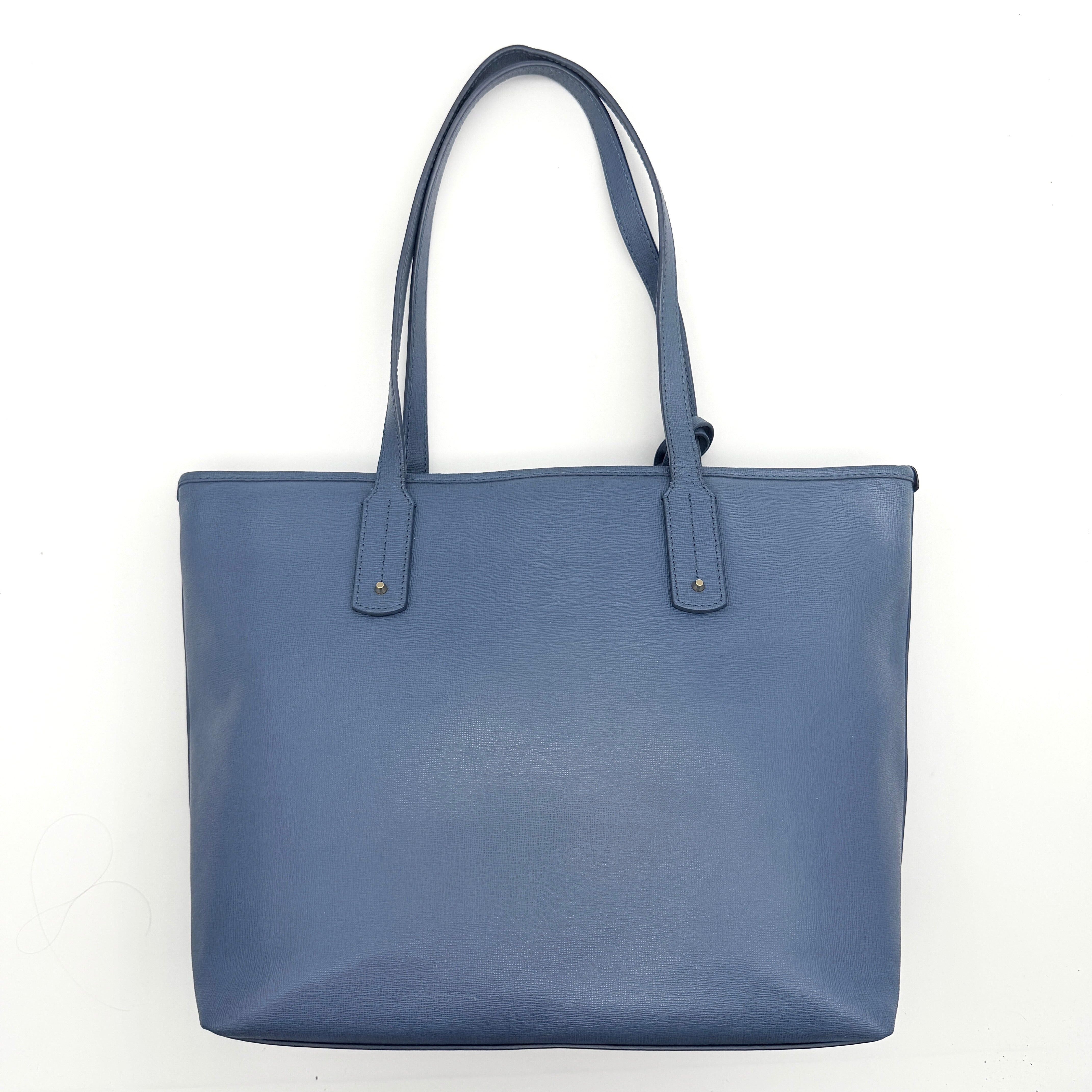 Furla New Daisy Tote Bag in blue leather with gold-tone logo charm and double handles, displayed against a white background