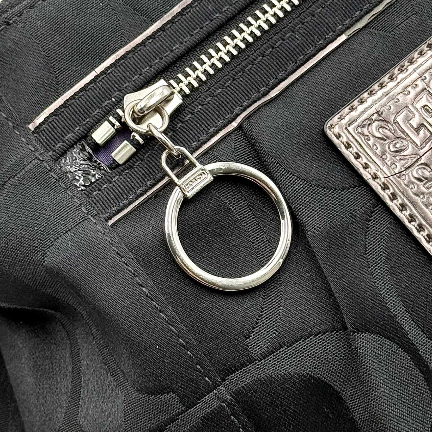 Coach black Signature Poppy Shoulder Bag with silver hardware, Coach tags, and tonal jacquard finish on a white background.