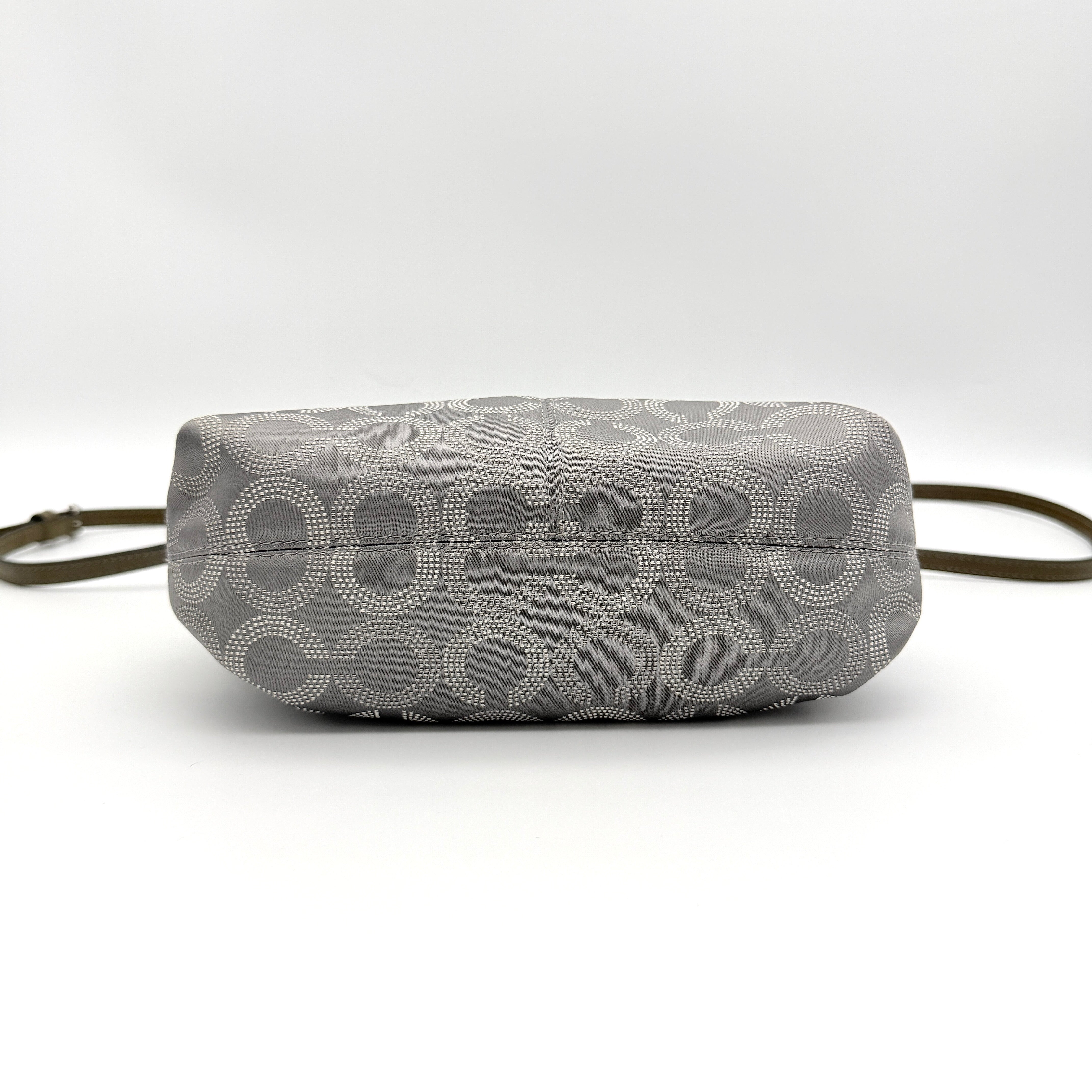 Coach Ashley Dotted Op Art crossbody bag in grey canvas with dotted monogram and adjustable strap, shown against a white background.
