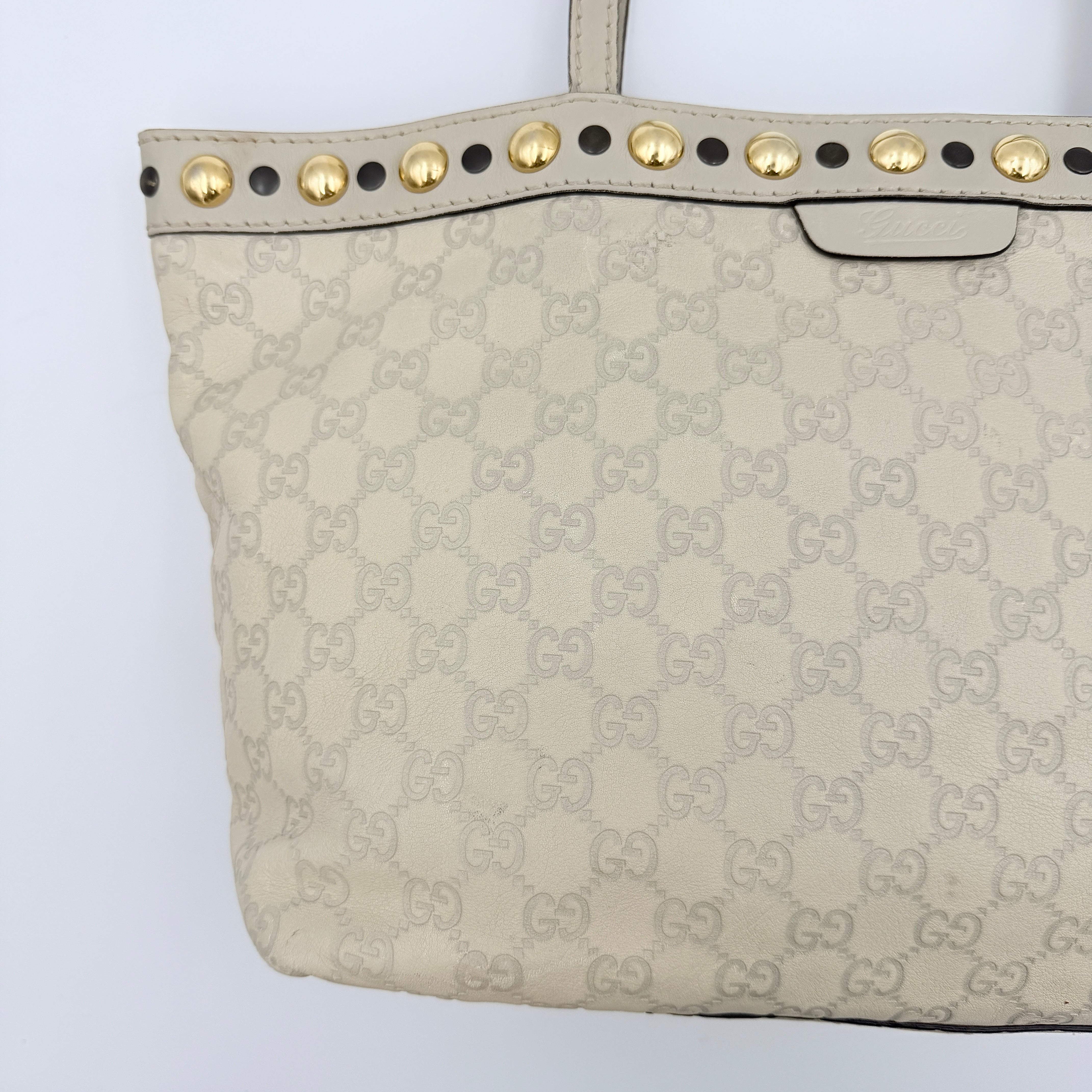 Gucci GG Monogram Babouska shoulder bag in cream canvas with gold-tone stud details and double top handles.