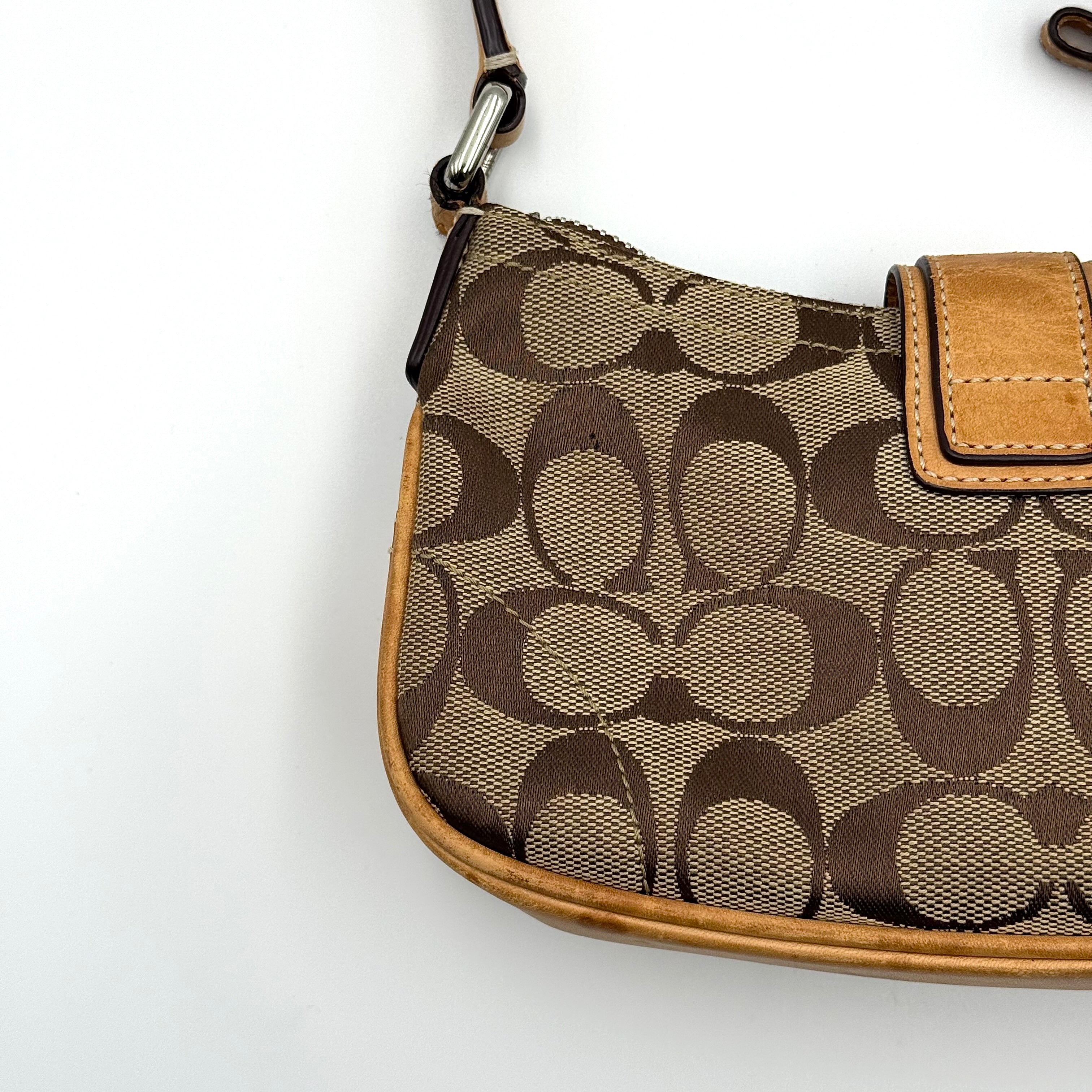 Coach Soho Demi shoulder bag in beige and tan monogram canvas with leather trim and buckle detail.