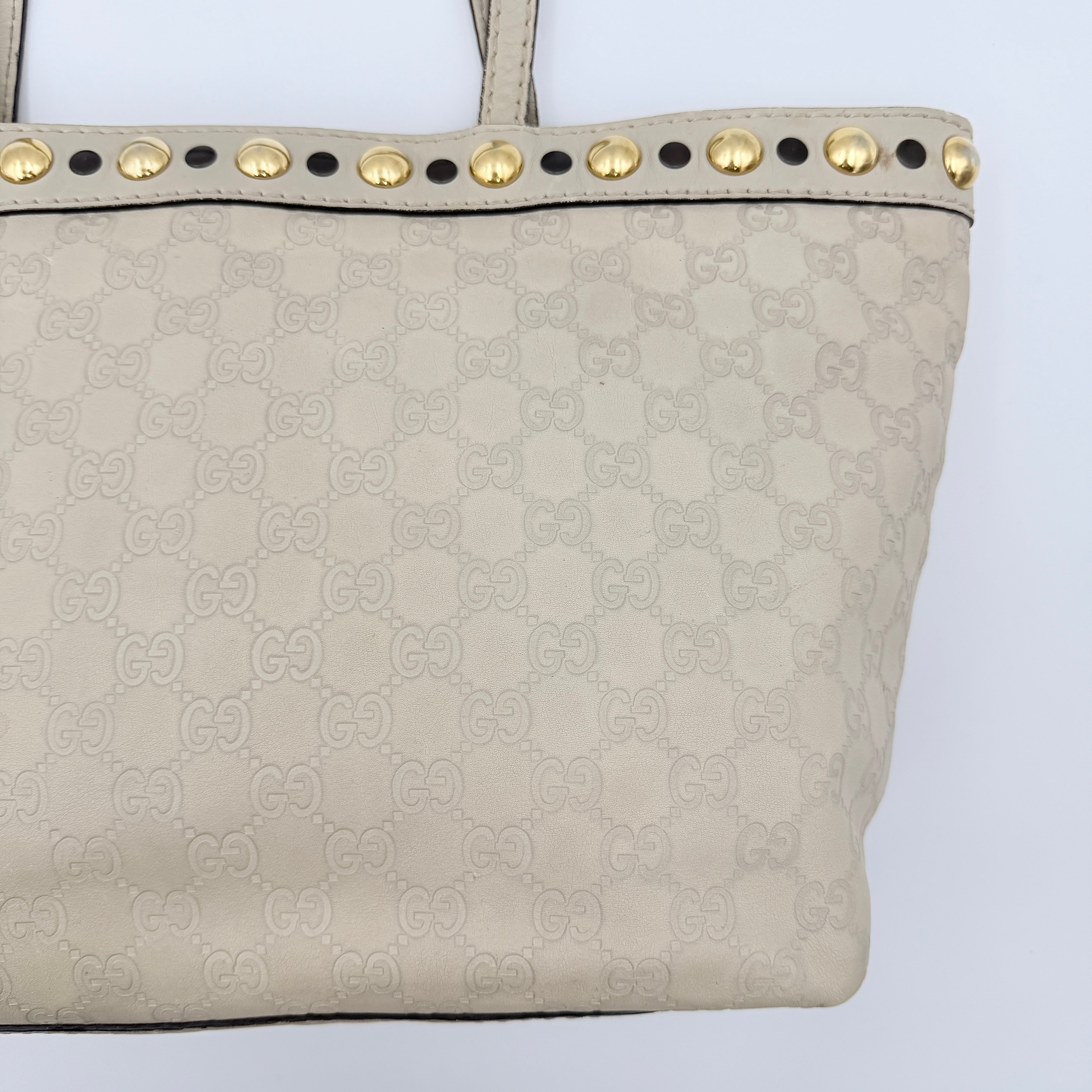 Gucci GG Monogram Babouska shoulder bag in cream canvas with gold-tone stud details and double top handles.