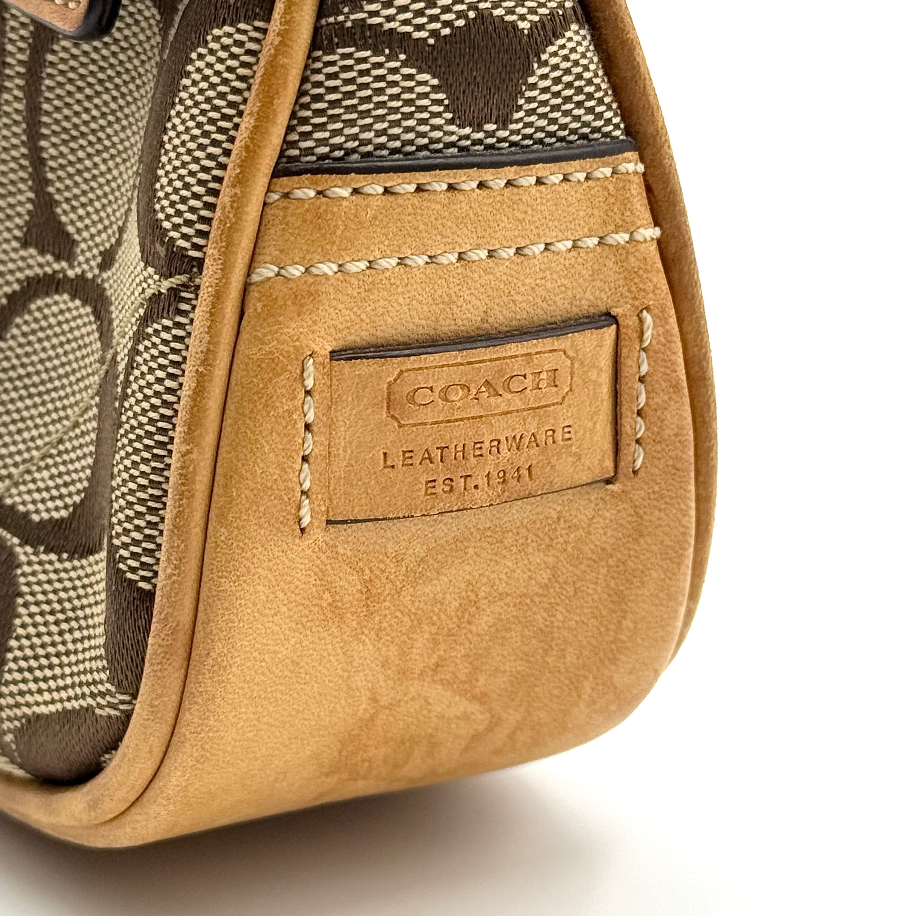 Coach Soho Demi shoulder bag in beige and tan monogram canvas with leather trim and buckle detail.