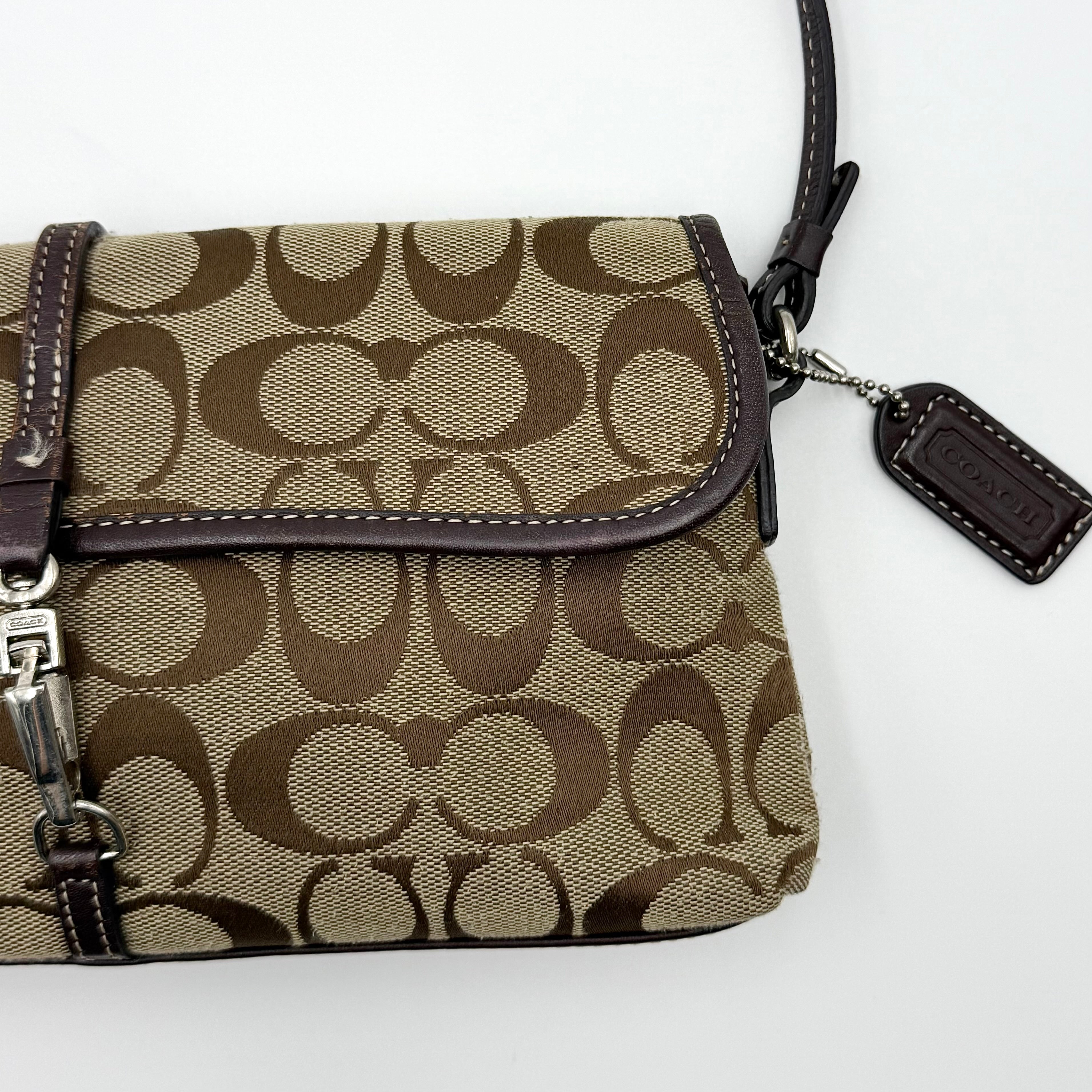 Coach Y2K Demi Clip Baguette in beige and brown canvas with leather trim, featuring signature monogram and shoulder strap.