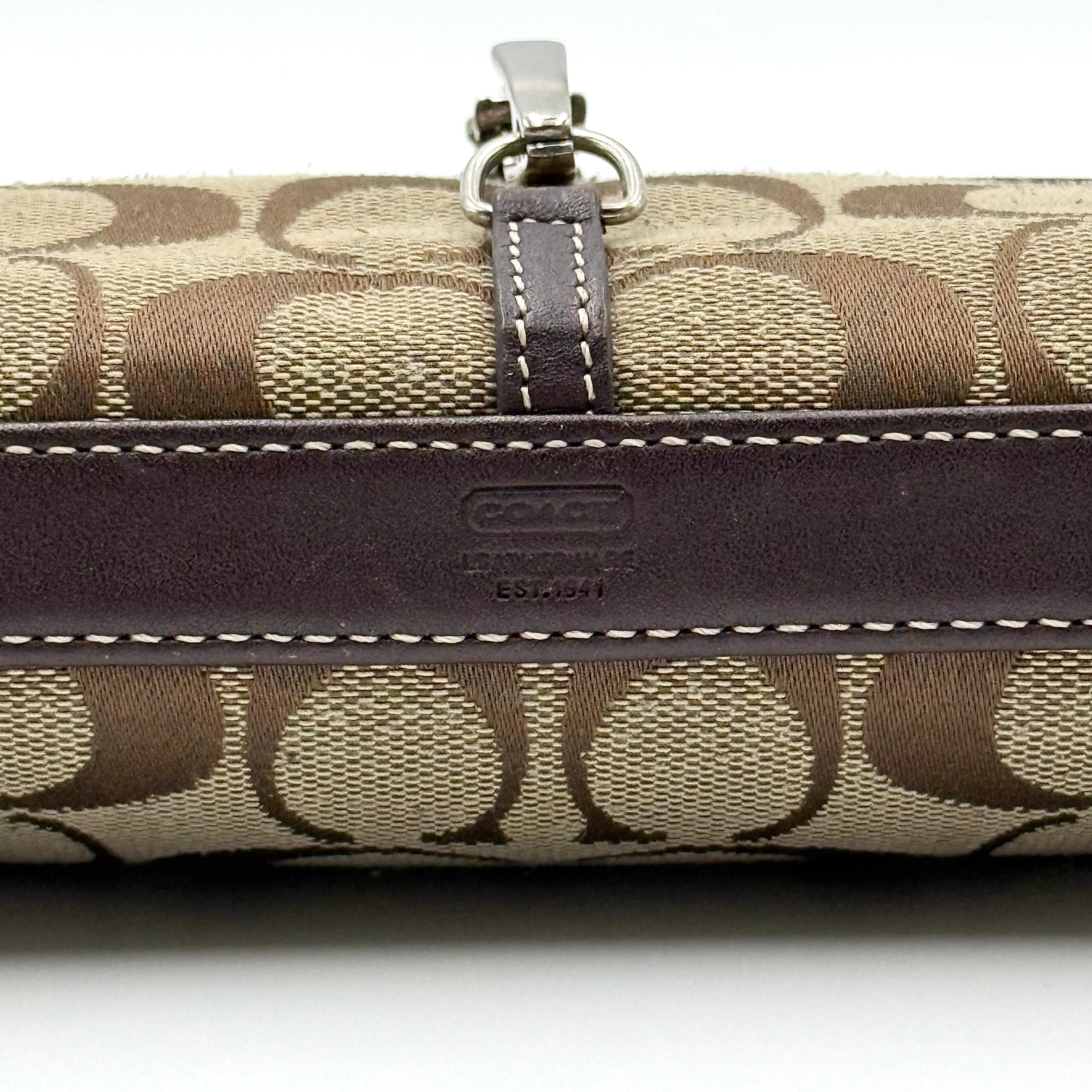 Coach Y2K Demi Clip Baguette in beige and brown canvas with leather trim, featuring signature monogram and shoulder strap.