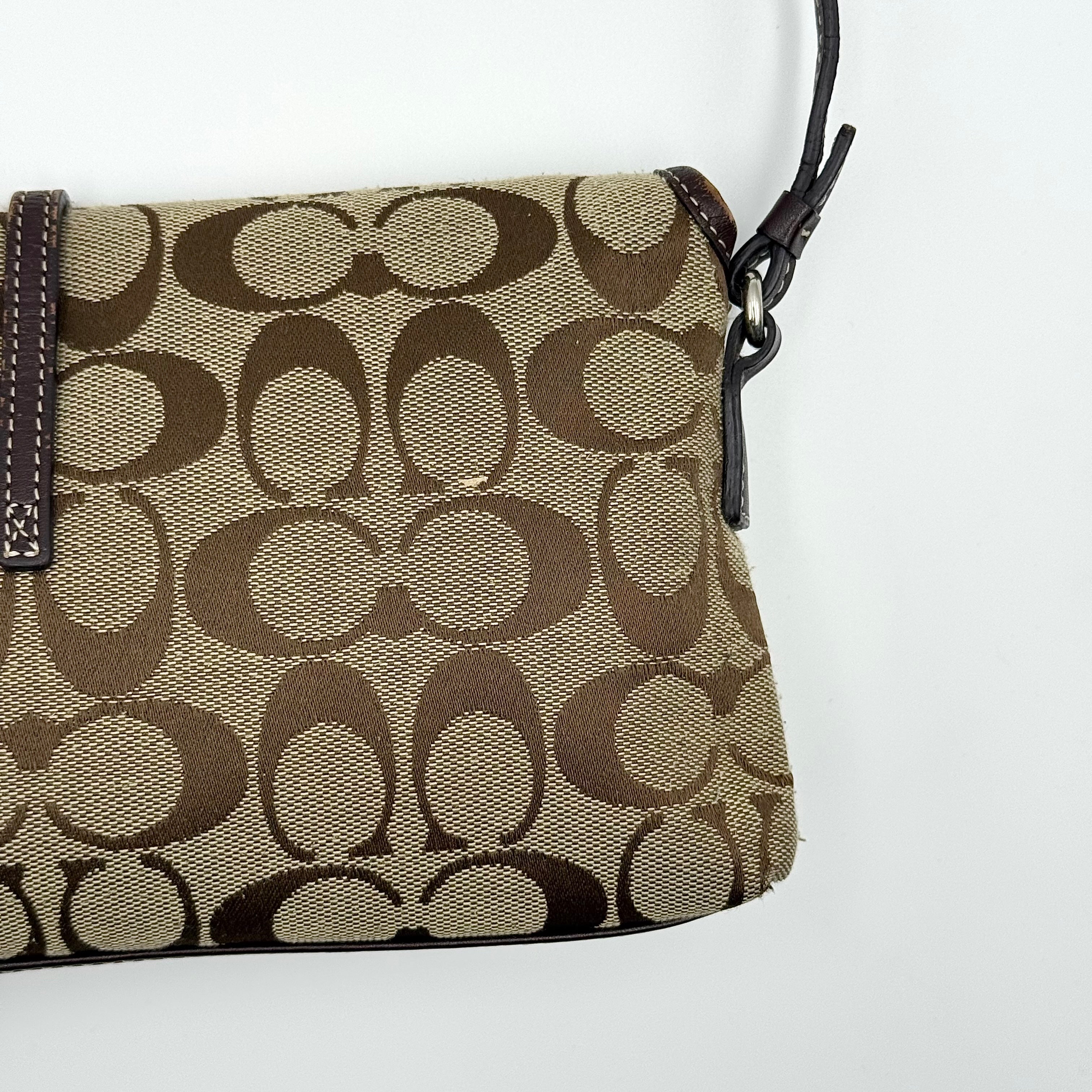 Coach Y2K Demi Clip Baguette in beige and brown canvas with leather trim, featuring signature monogram and shoulder strap.