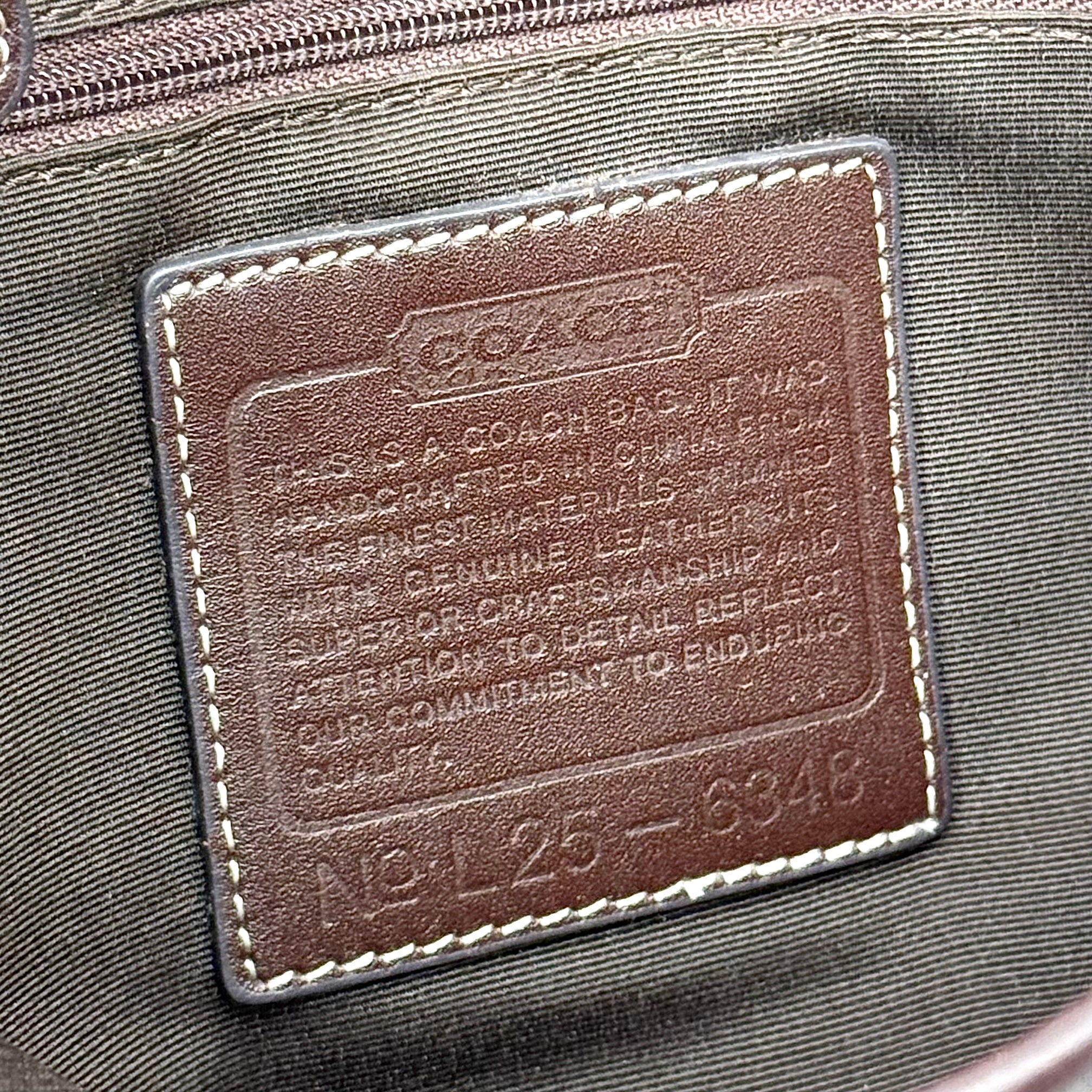 Coach Y2K Demi Clip Baguette in beige and brown canvas with leather trim, featuring signature monogram and shoulder strap.