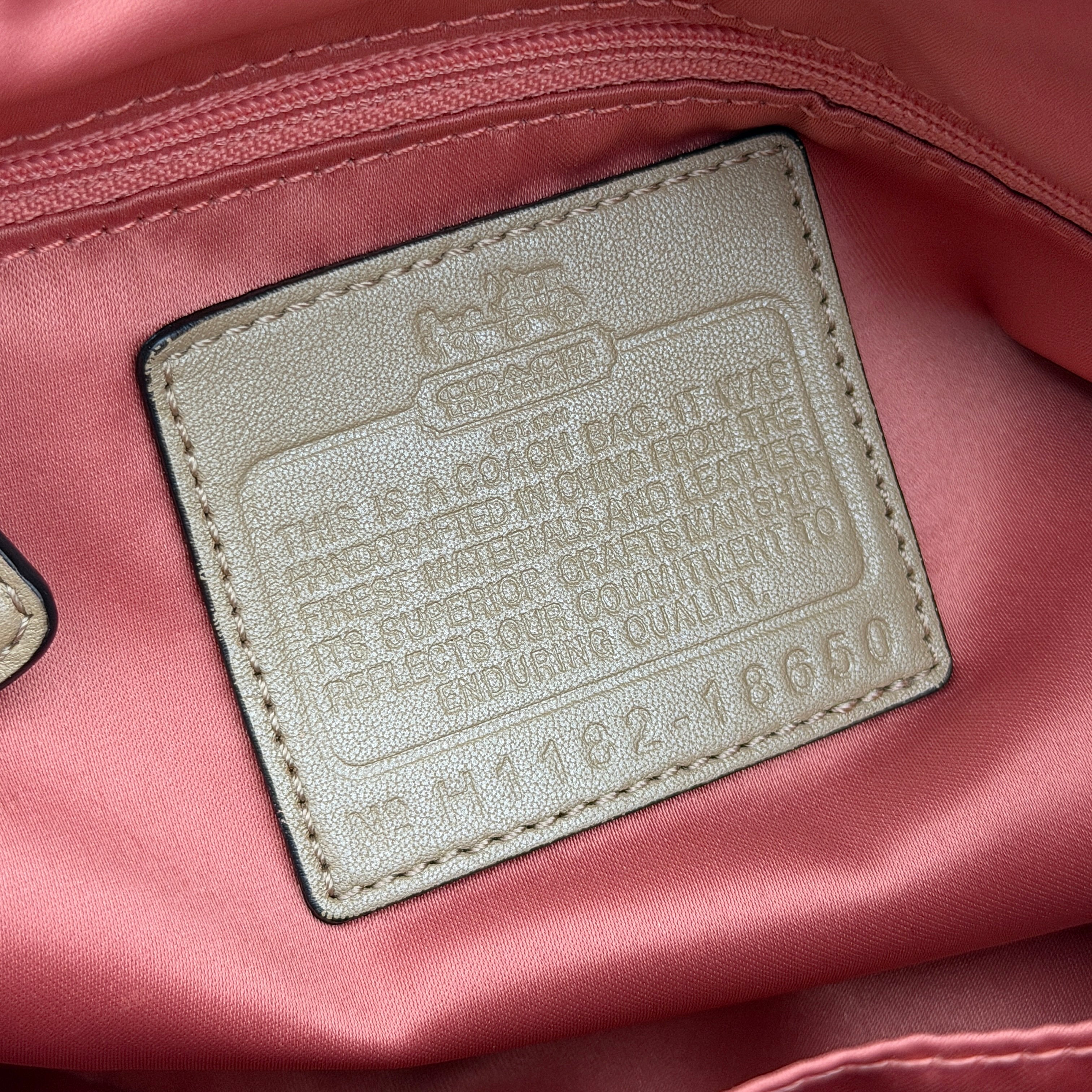 Beige Coach Madison Op Art Sophia shoulder bag with ivory leather handles, gold hardware, and detachable strap.