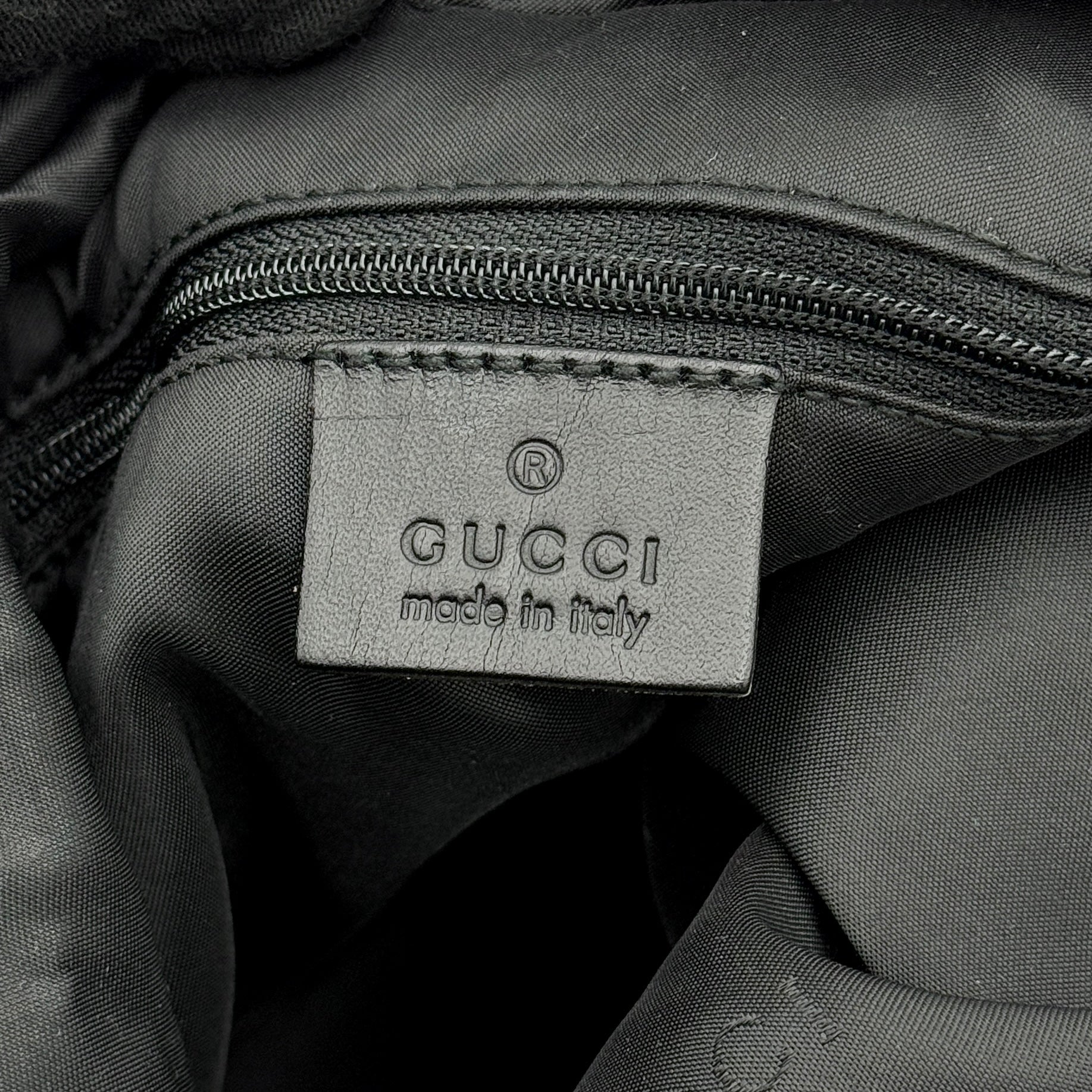 Gucci GG Monogram Hobo Shoulder Bag in black canvas with tonal GG logo pattern, silver-tone hardware and a single top handle.