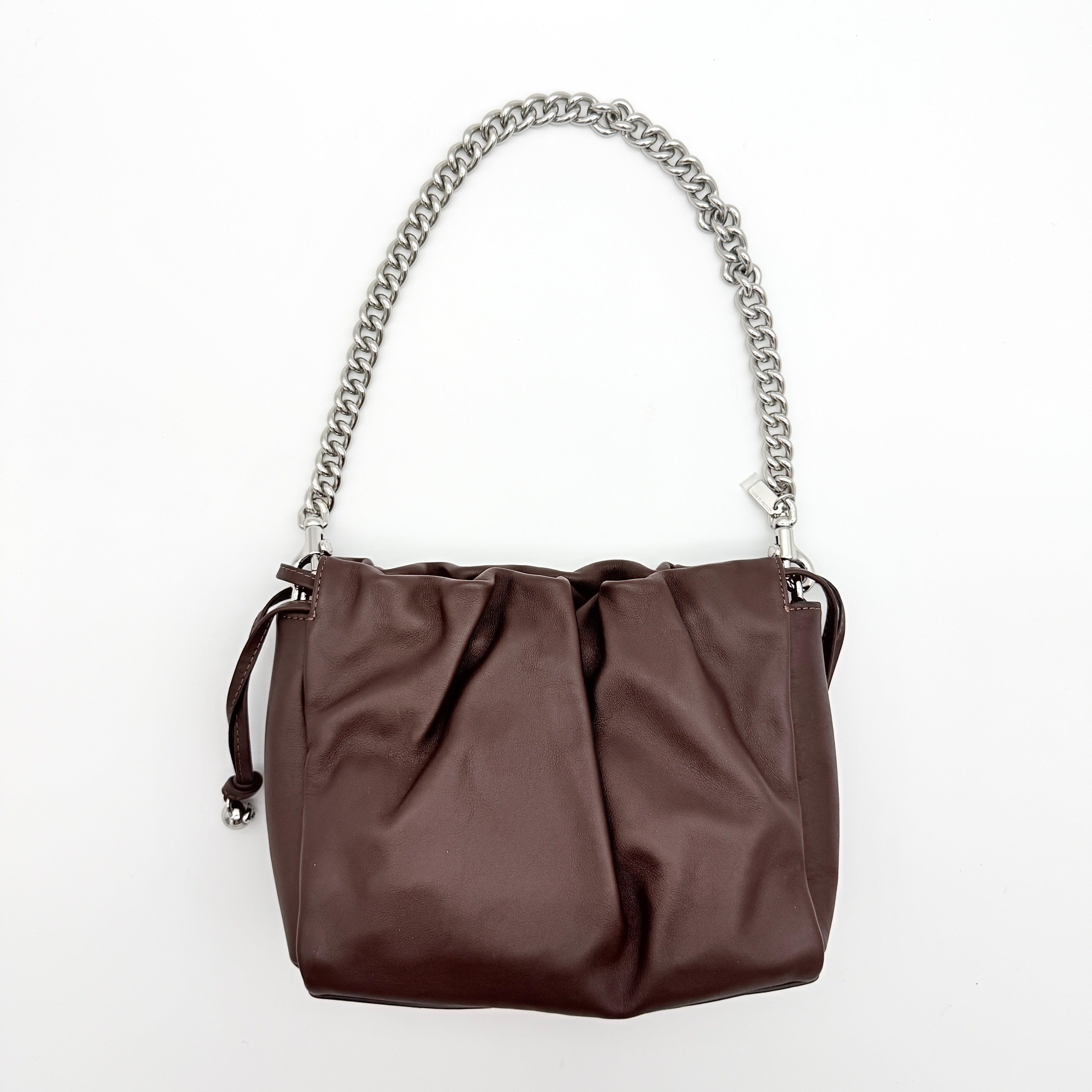 Coach Faye shoulder bag in brown leather with chunky silver-tone chain handle and detachable strap, displayed against a white background.