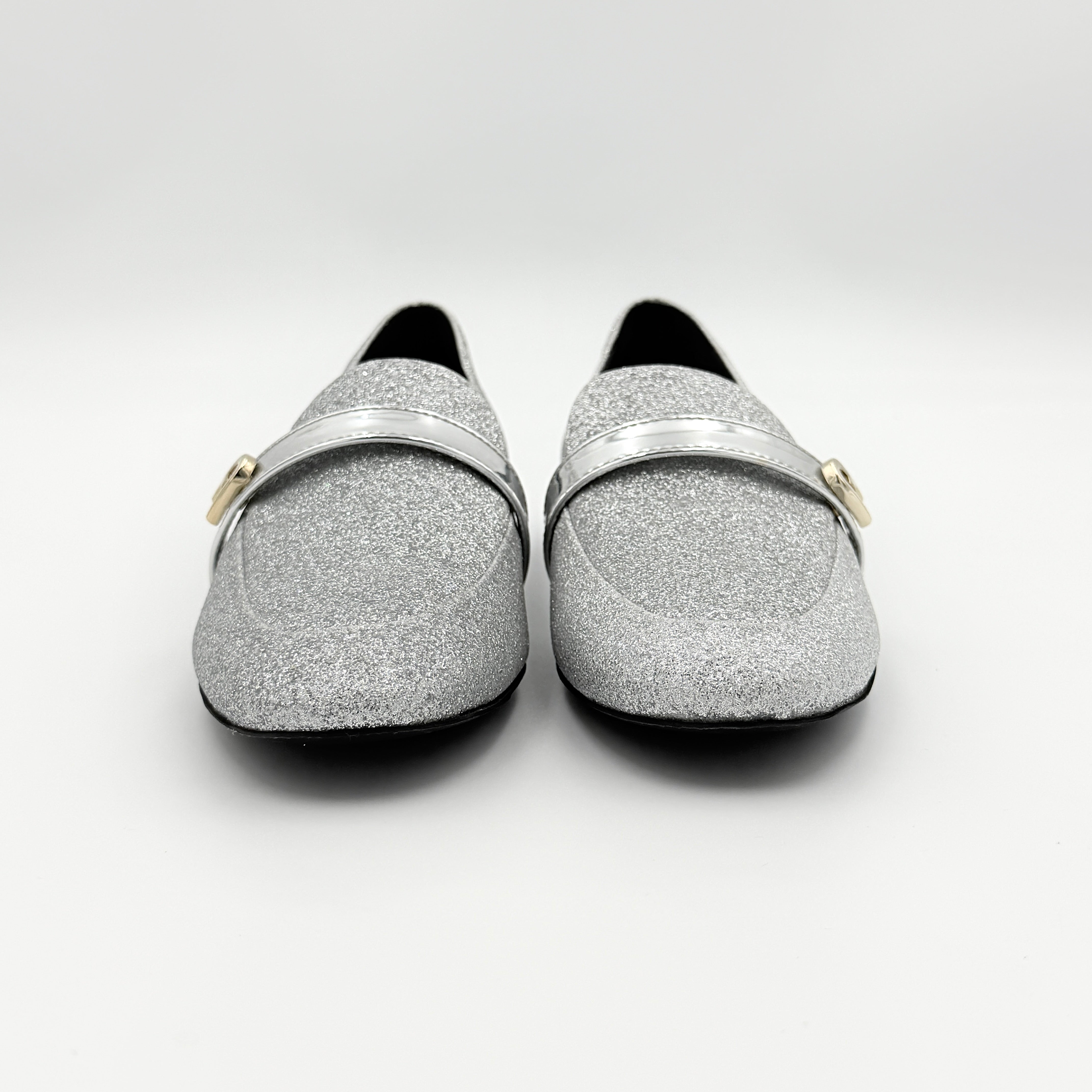Furla 1927 T.20 loafers in silver microglitter with metallic strap and gold-tone detail, displayed in a three-quarter view.