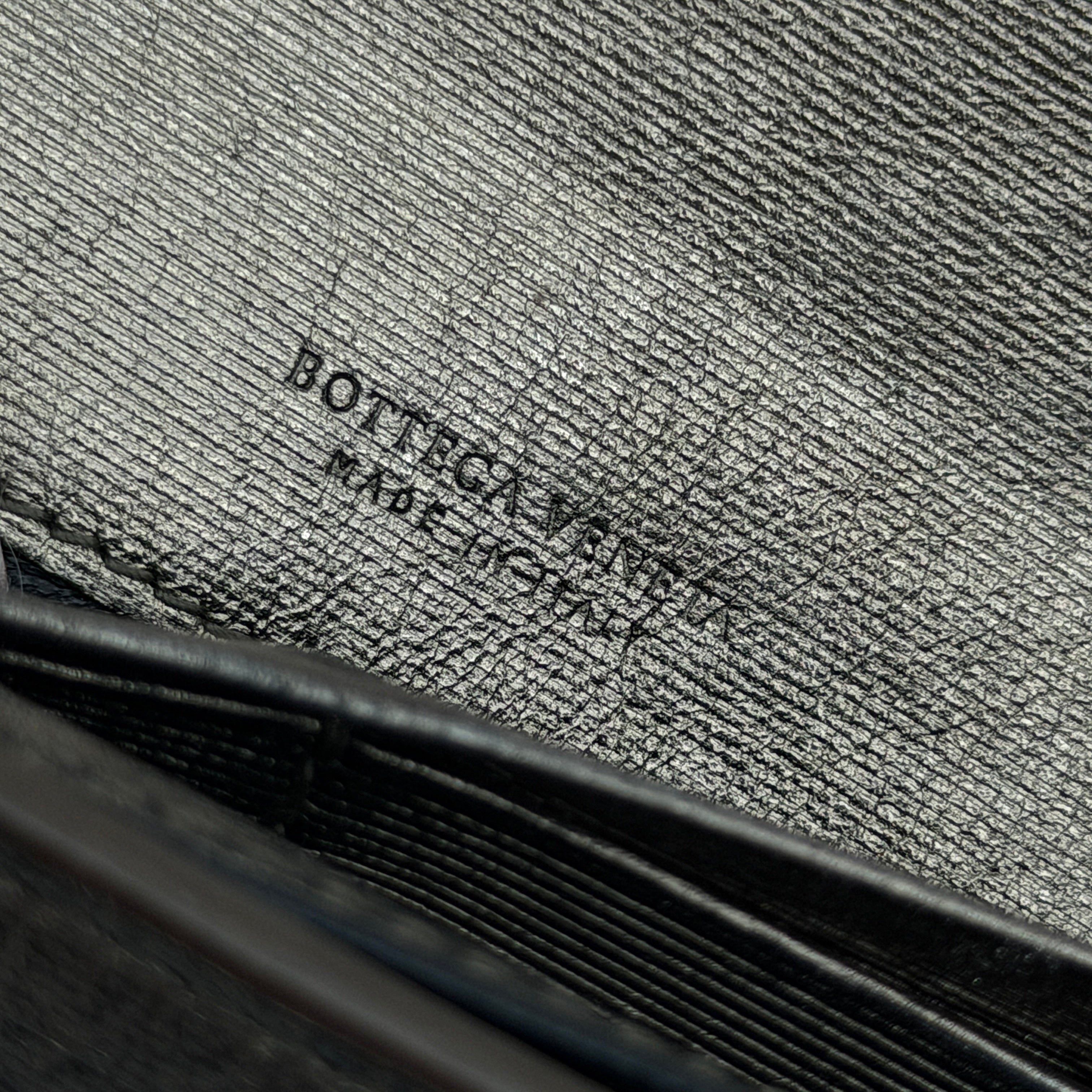 Bottega Veneta Intrecciato Flap Continental Long Wallet in metallic grey with woven leather finish, shown closed on a white background.