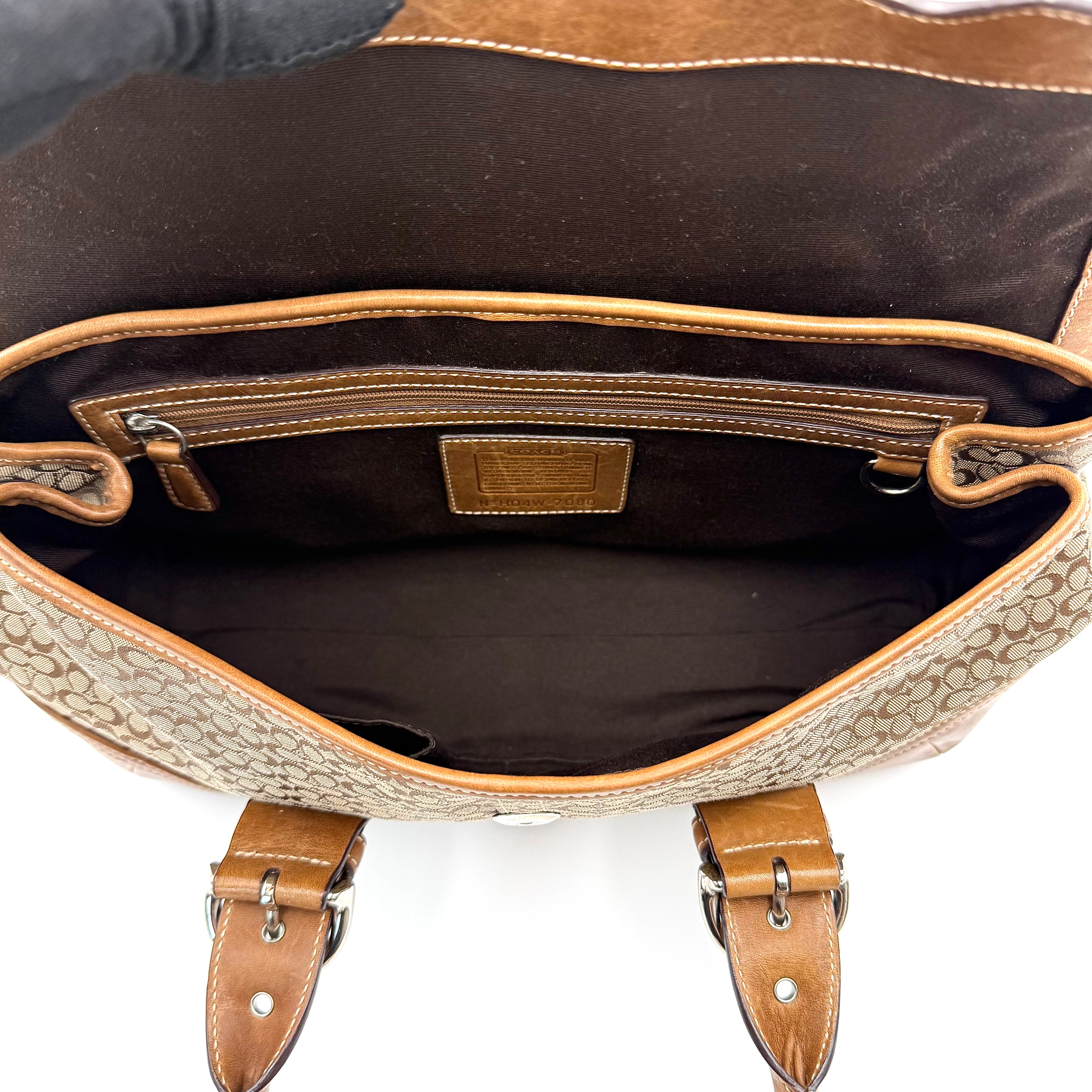 Coach Soho Hampton satchel in beige jacquard canvas with tan leather trim and rolled handles shown against a white background.