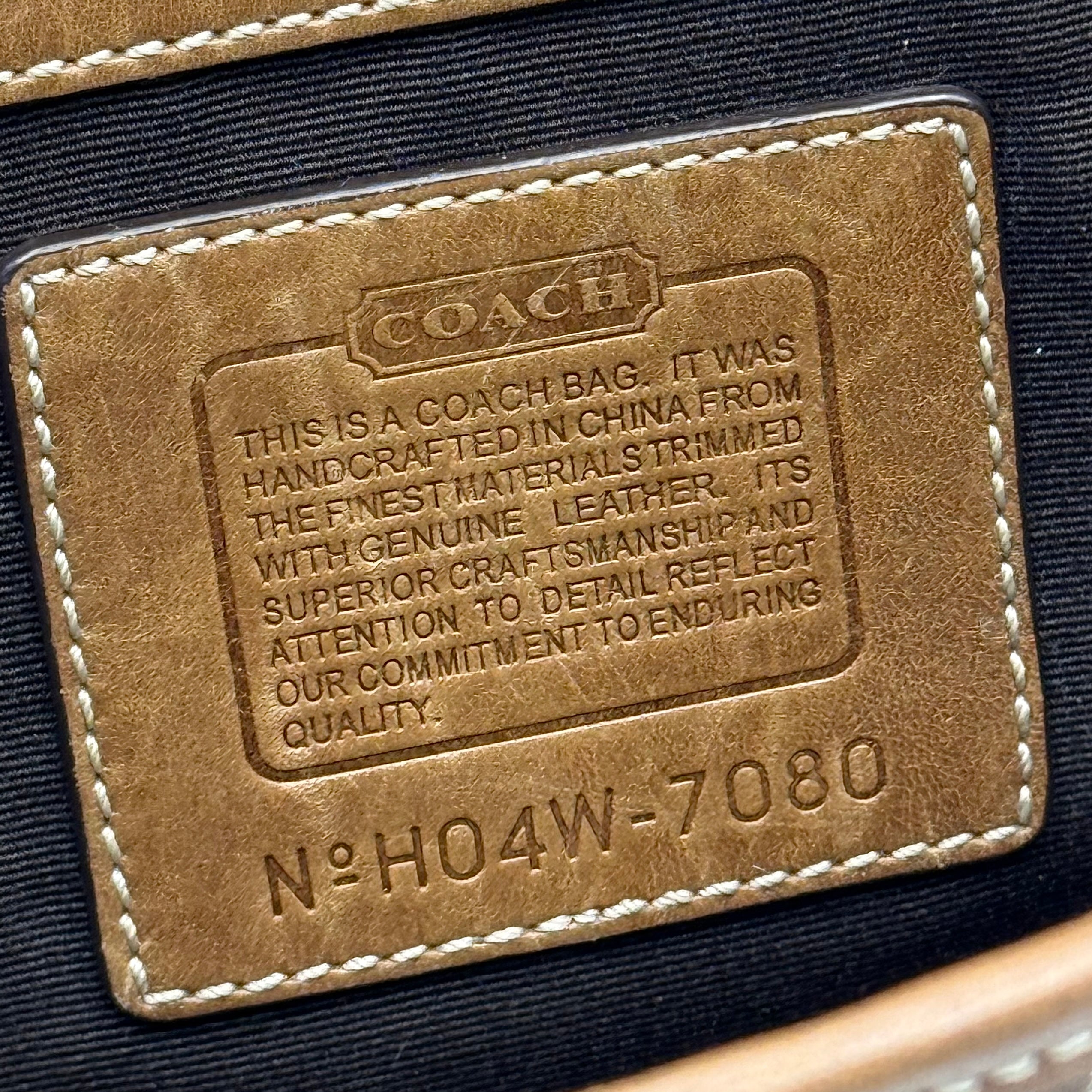 Coach Soho Hampton satchel in beige jacquard canvas with tan leather trim and rolled handles shown against a white background.