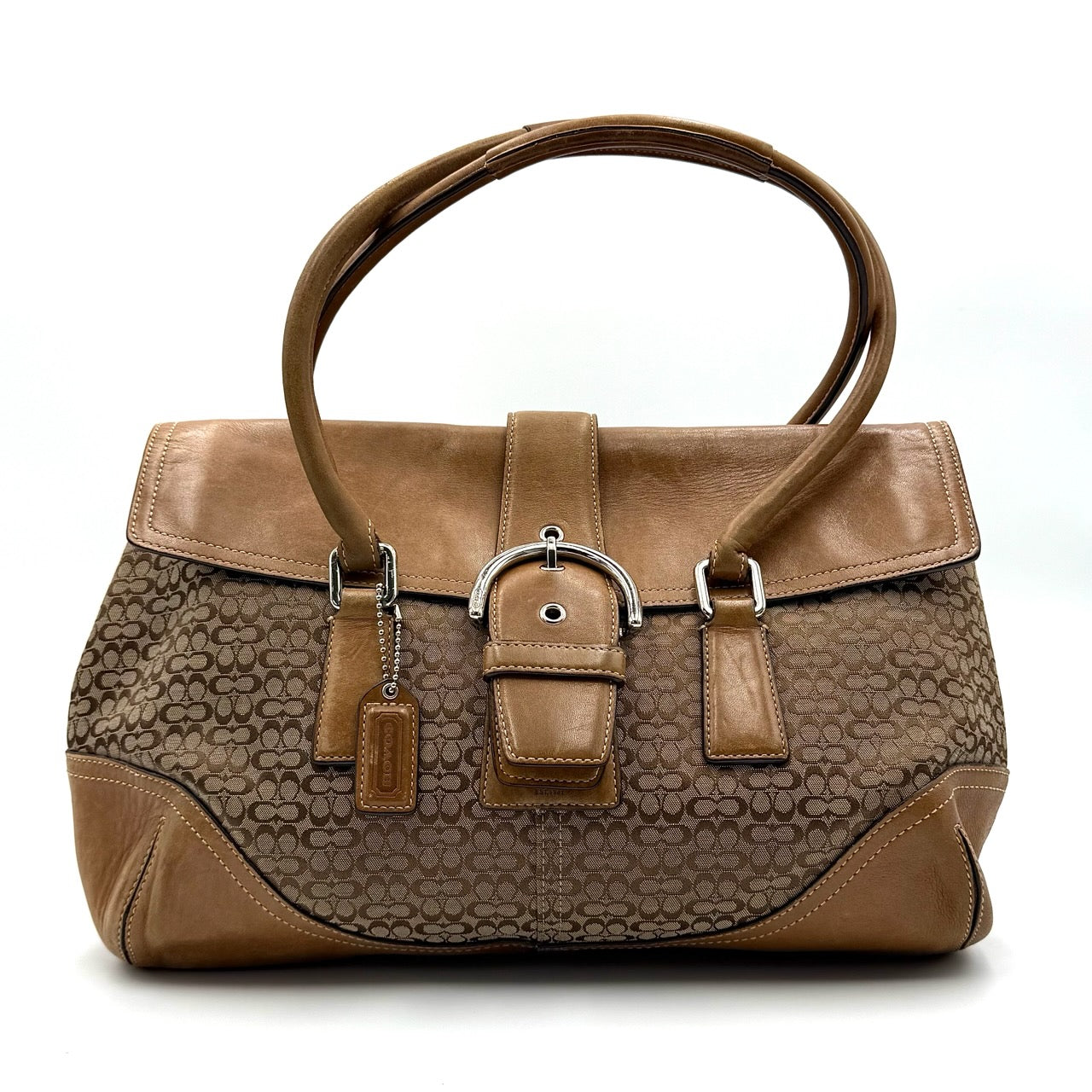 Coach Signature Soho shoulder bag in beige and tan canvas with leather trim and silver buckle.