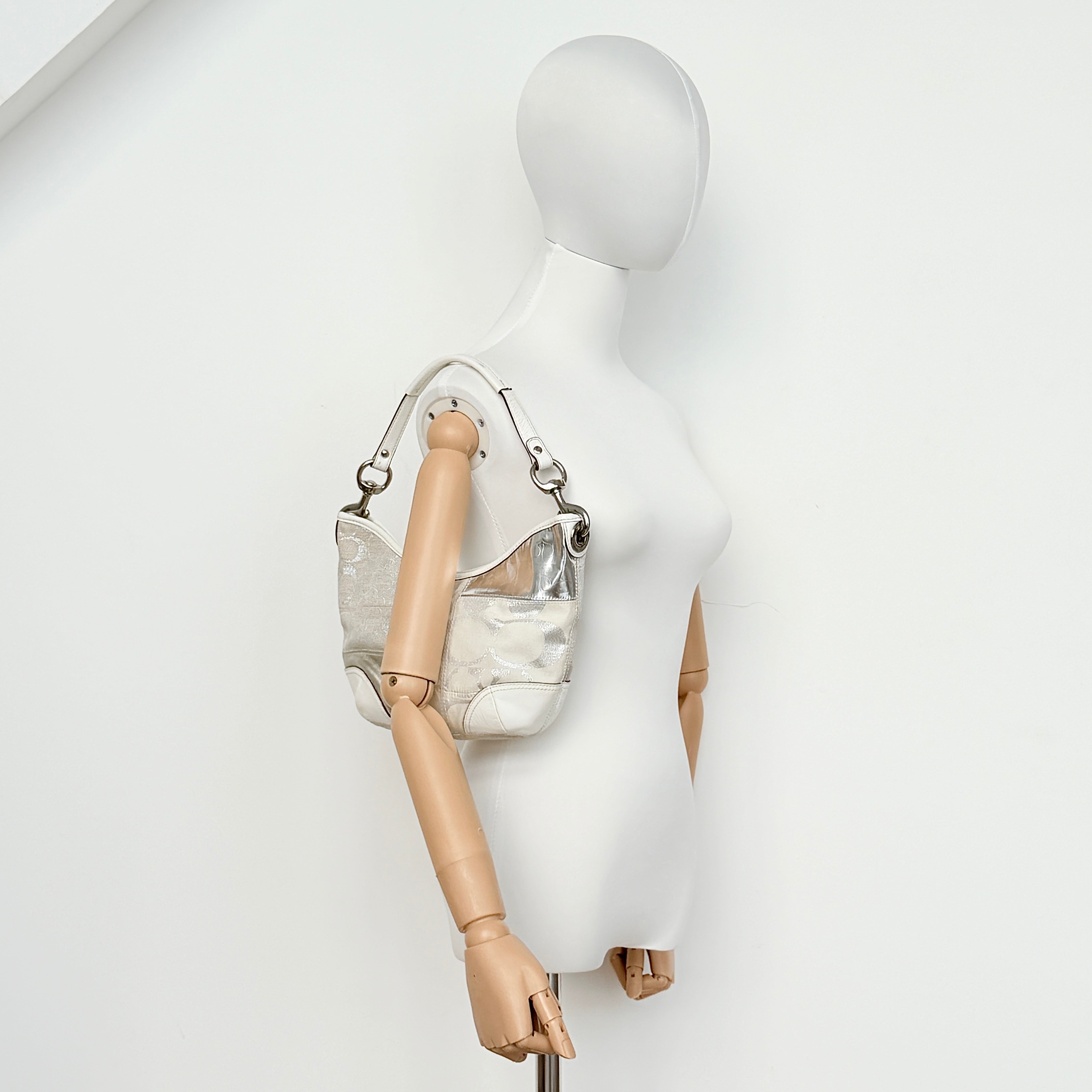 Coach Y2K Signature Patchwork Hobo Shoulder Bag in cream and silver jacquard with wide leather handle, shown on a white background.
