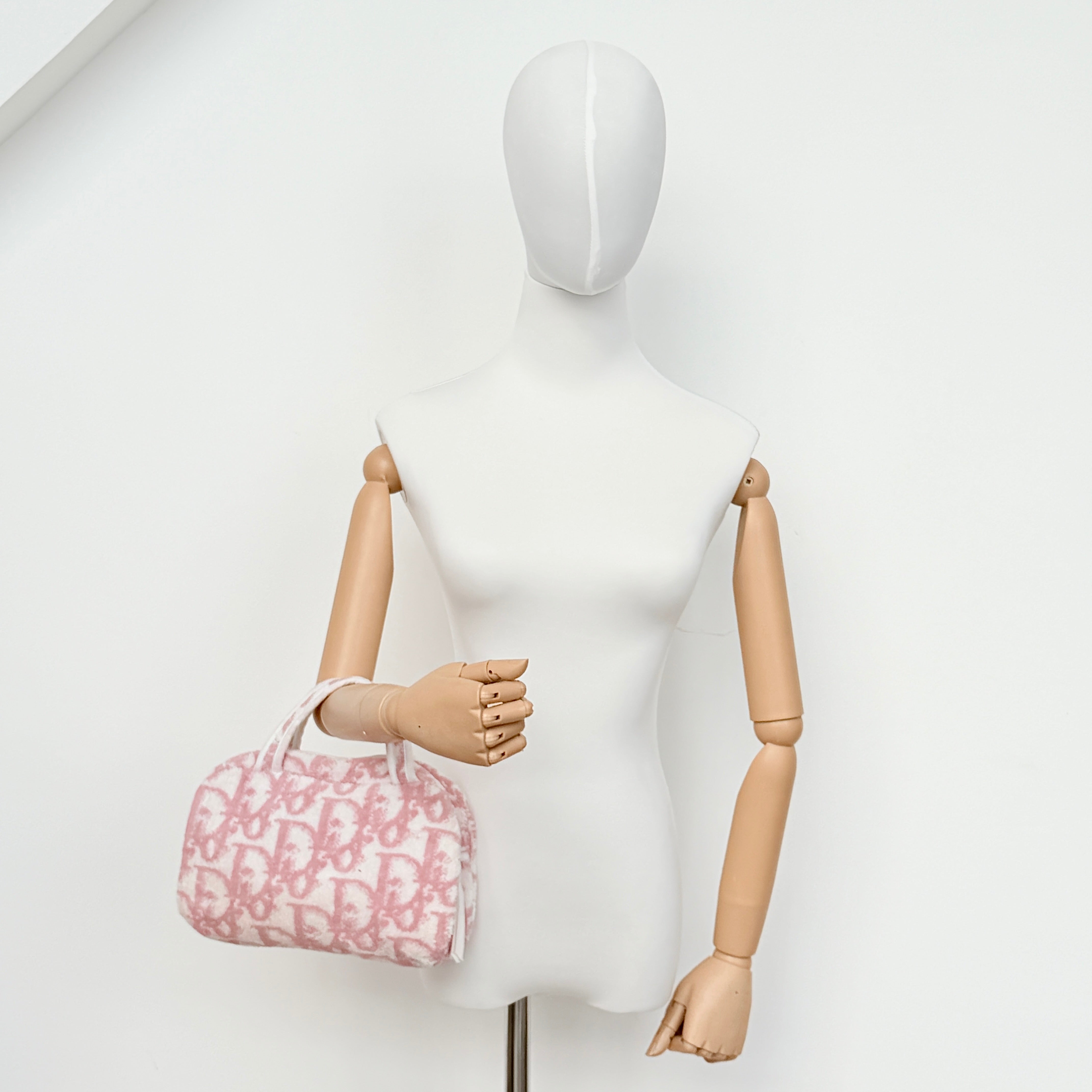 Christian Dior pink and white Trotter terry cloth mini bag with top handles and zip closure, displayed on a white background.