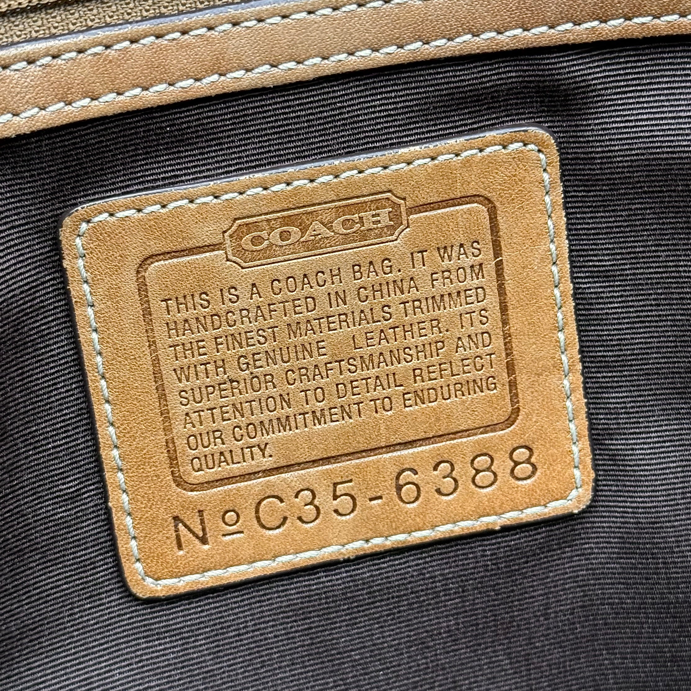 Coach Signature Soho shoulder bag in beige and tan canvas with leather trim and silver buckle.